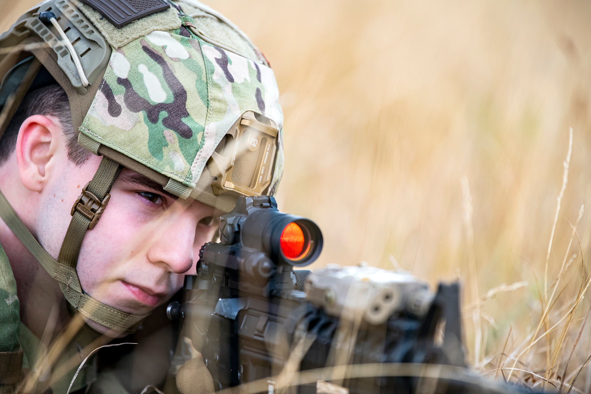 U.S. Air Force Senior Airman Joshua Cross, 423d Security Forces Squadron physical security, looks down the sight of an M4 carbine during a field training exercise at Stanford Training Area, England, Aug. 17, 2022. Instructors from the 820th Base Defense Group and 435th Security Forces Squadron Ground Combat Readiness Training Center, conducted the exercise to evaluate and bolster the combat readiness skills of the defenders from the 423d SFS. (U.S. Air Force photo by Staff Sgt. Eugene Oliver)