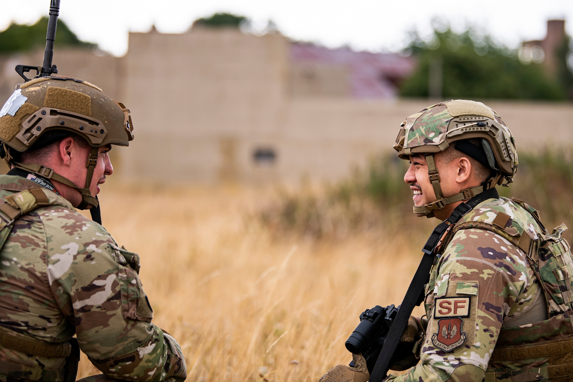 U.S. Air Force Staff Sgt. Noel Rillona, left, 423d Security Forces Squadron flight trainer, speaks with U.S. Air Force Senior Airman Ambrose Ross, 423d Security forces squadron police services, during a field training exercise at Stanford Training Area, England, Aug. 17, 2022. Instructors from the 820th Base Defense Group and 435th Security Forces Squadron Ground Combat Readiness Training Center, conducted the exercise to evaluate and bolster the combat readiness skills of the defenders from the 423d SFS. (U.S. Air Force photo by Staff Sgt. Eugene Oliver)