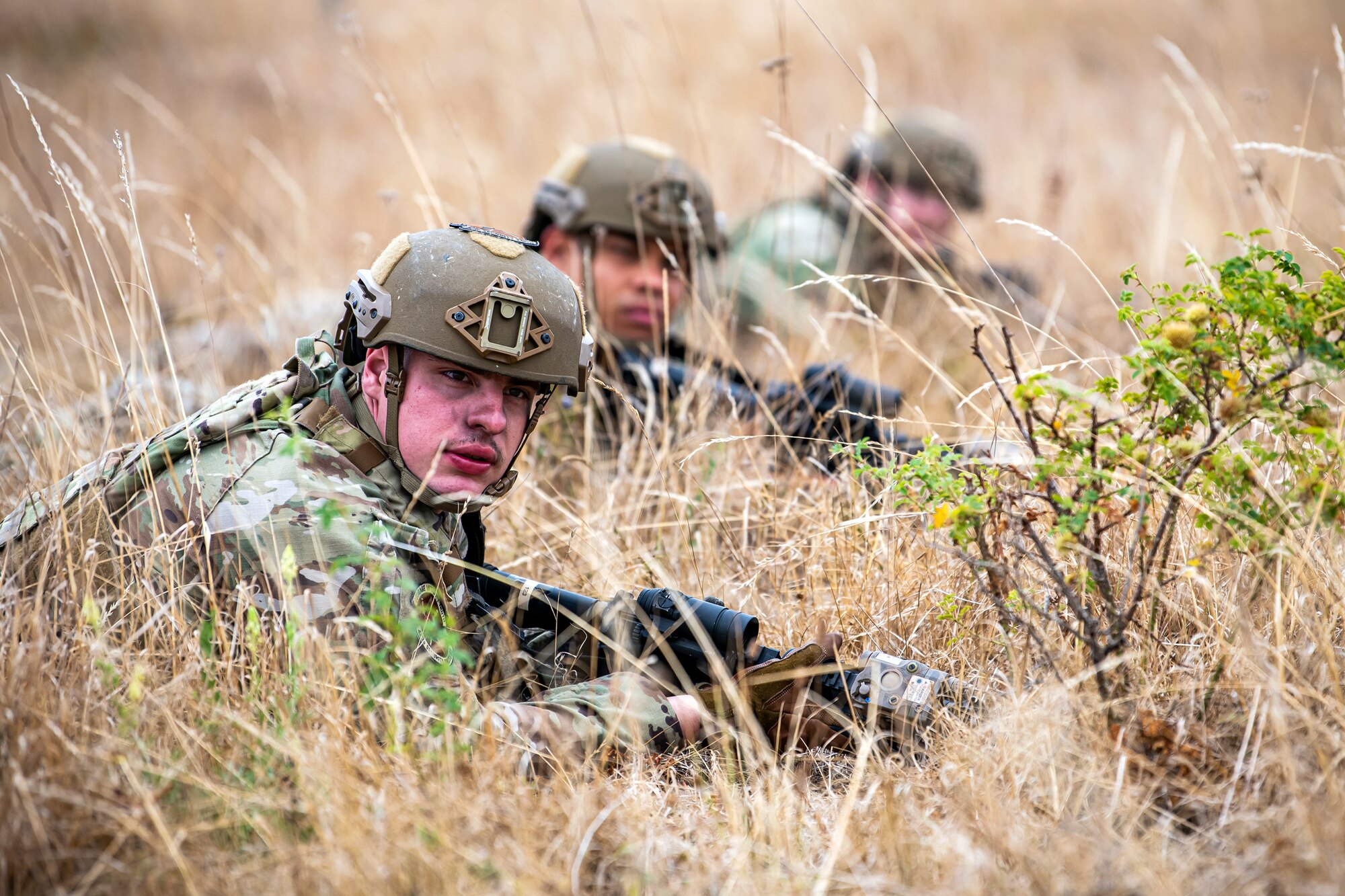 Airmen from the 423d Security Forces Squadron lay prone with their weapons during a field training exercise at Stanford Training Area, England, Aug. 17, 2022. Instructors from the 820th Base Defense Group and 435th Security Forces Squadron Ground Combat Readiness Training Center, conducted the exercise to evaluate and bolster the combat readiness skills of the defenders from the 423d SFS. (U.S. Air Force photo by Staff Sgt. Eugene Oliver)
