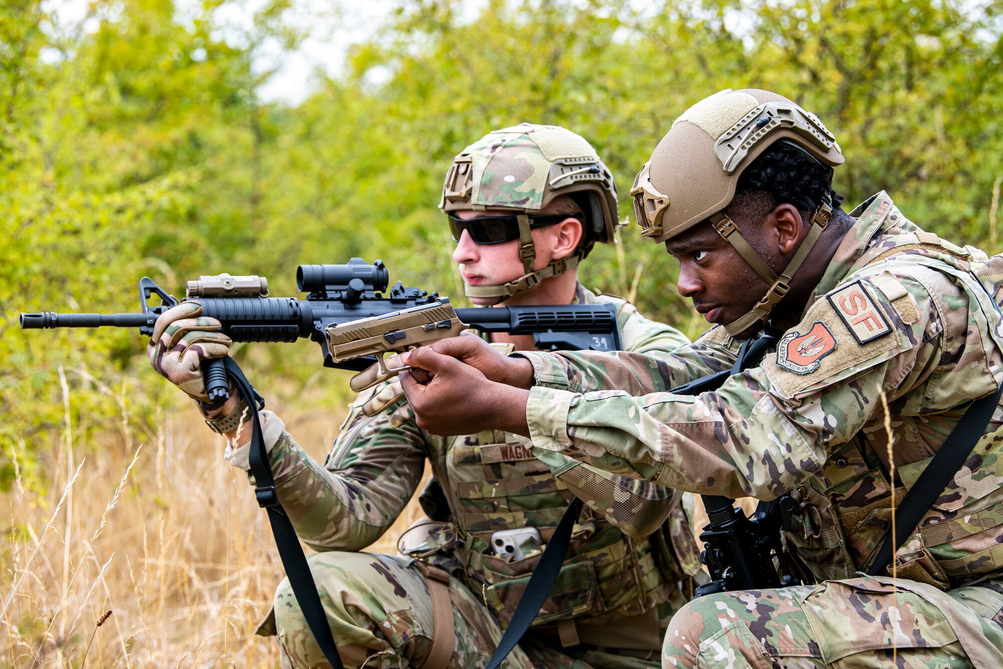 Airmen from the 423d Security Forces Squadron hold their position during a field training exercise at Stanford Training Area, England, Aug. 17, 2022. Instructors from the 820th Base Defense Group and 435th Security Forces Squadron Ground Combat Readiness Training Center, conducted the exercise to evaluate and bolster the combat readiness skills of the defenders from the 423d SFS. (U.S. Air Force photo by Staff Sgt. Eugene Oliver)