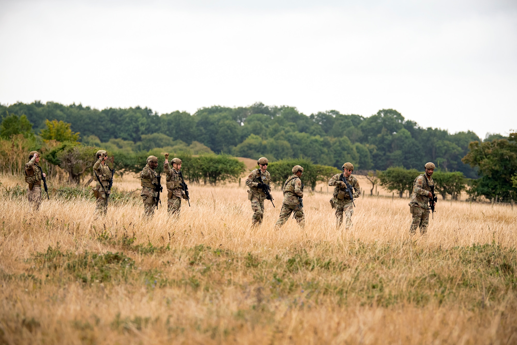 Airmen from the 423d Security Forces Squadron stand in a wedge formation during a field training exercise at Stanford Training Area, England, Aug. 17, 2022. Instructors from the 820th Base Defense Group and 435th Security Forces Squadron Ground Combat Readiness Training Center, conducted the exercise to evaluate and bolster the combat readiness skills of the defenders from the 423d SFS. (U.S. Air Force photo by Staff Sgt. Eugene Oliver)