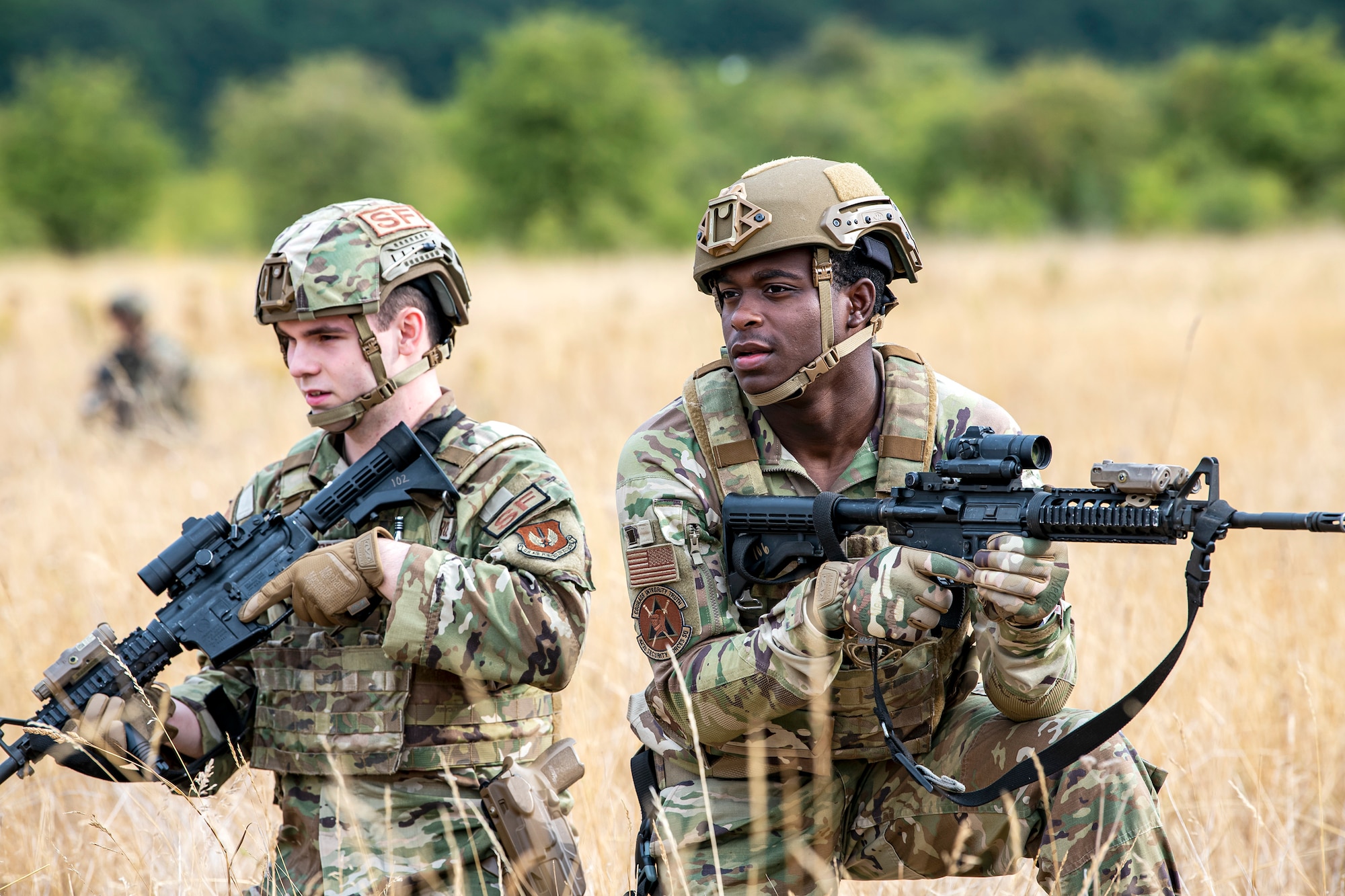 U.S. Air Force Senior Airman Joshua Cross, left, 423d Security Forces Squadron physical security, along with another member from the 423d SFS, holds position during a field training exercise at Stanford Training Area, England, Aug. 17, 2022. Instructors from the 820th Base Defense Group and 435th Security Forces Squadron Ground Combat Readiness Training Center, conducted the exercise to evaluate and bolster the combat readiness skills of the defenders from the 423d SFS. (U.S. Air Force photo by Staff Sgt. Eugene Oliver)
