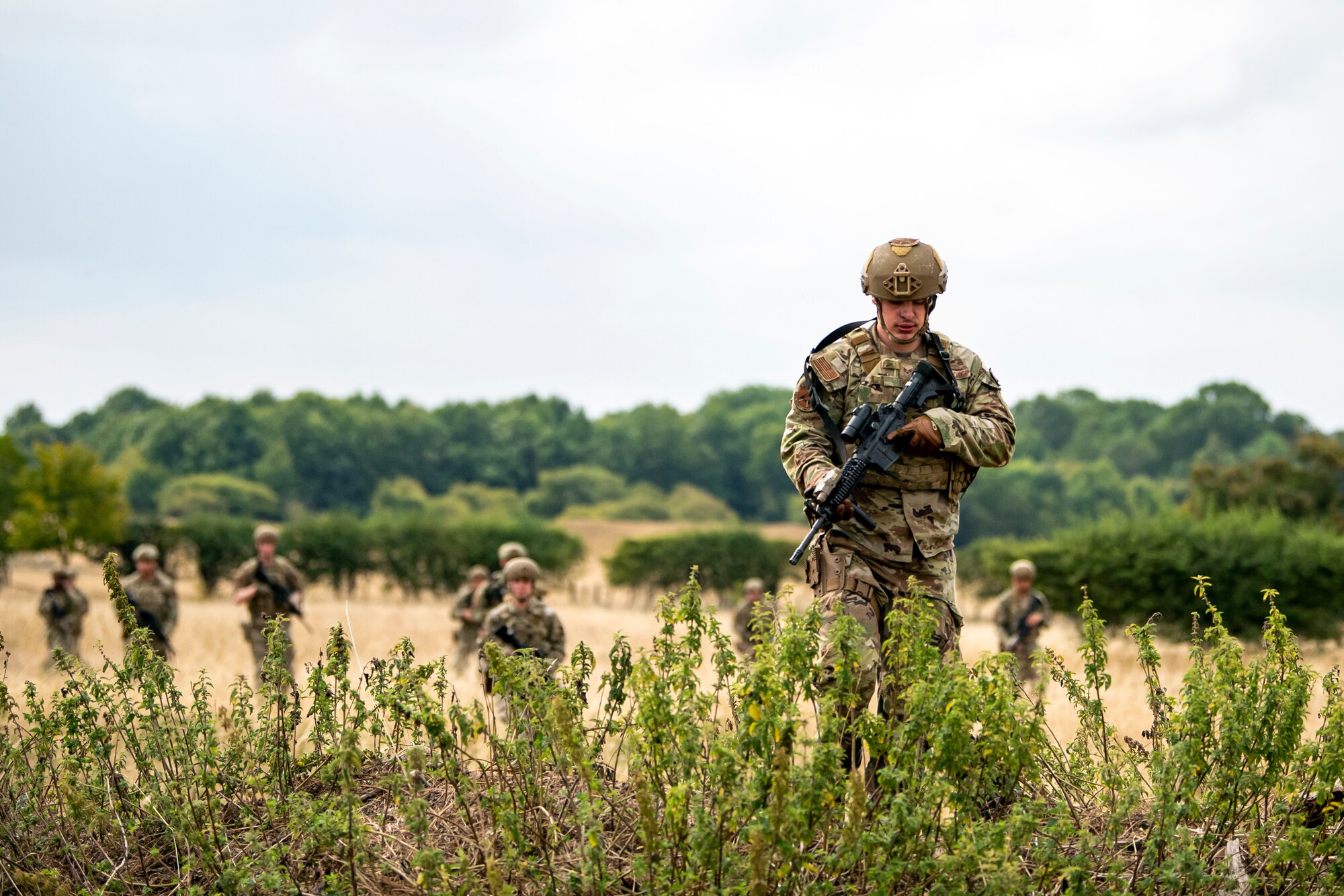 Airmen from the 423d Security Forces Squadron advance their position during a field training exercise at Stanford Training Area, England, Aug. 17, 2022. Instructors from the 820th Base Defense Group and 435th Security Forces Squadron Ground Combat Readiness Training Center, conducted the exercise to evaluate and bolster the combat readiness skills of the defenders from the 423d SFS. (U.S. Air Force photo by Staff Sgt. Eugene Oliver)