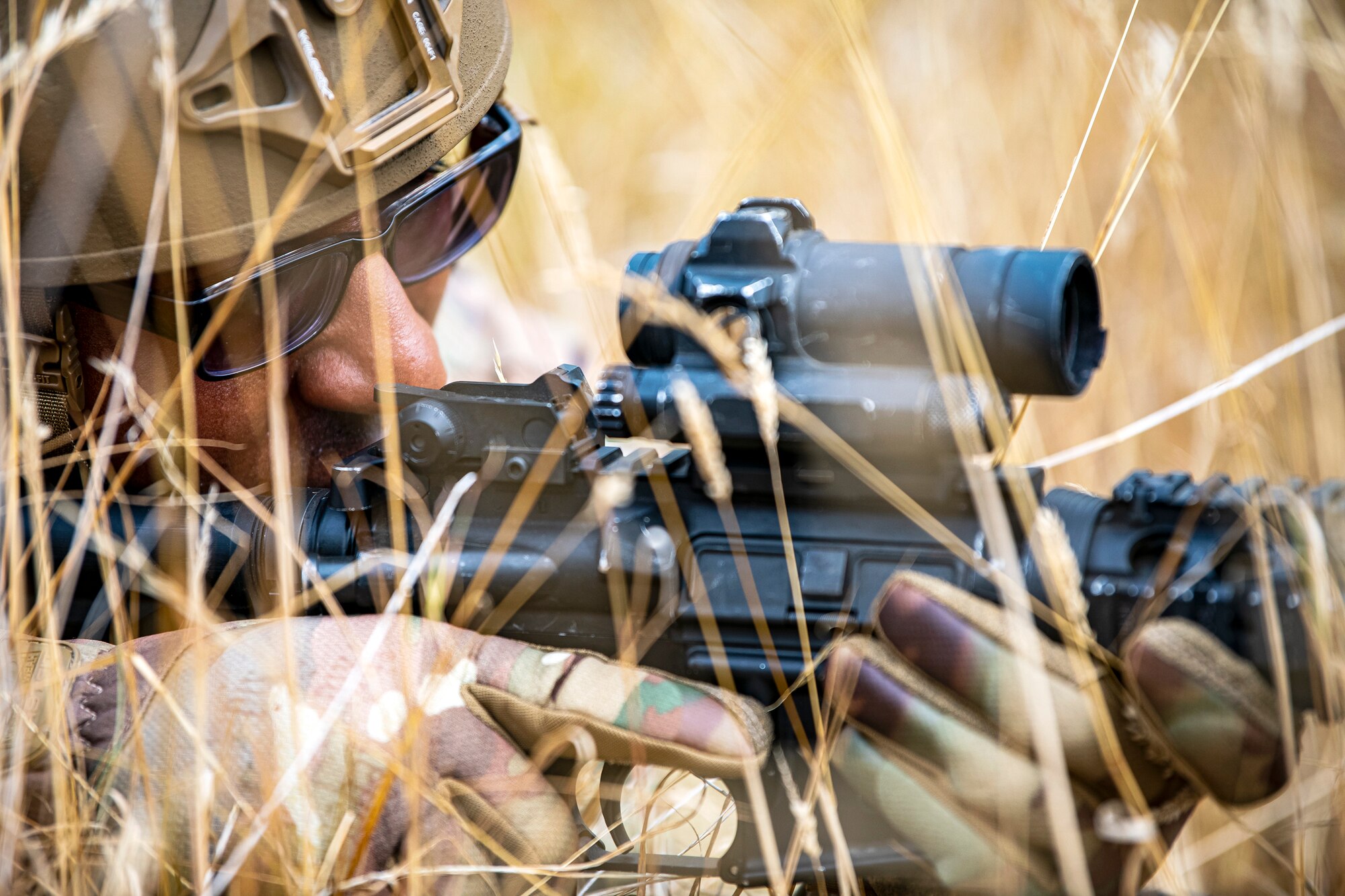 An Airman from the 423d Security Forces Squadron lays prone while looking down the sights of an M4 carbine during a field training exercise at Stanford Training Area, England, Aug. 17, 2022. Instructors from the 820th Base Defense Group and 435th Security Forces Squadron Ground Combat Readiness Training Center, conducted the exercise to evaluate and bolster the combat readiness skills of the defenders from the 423d SFS. (U.S. Air Force photo by Staff Sgt. Eugene Oliver)