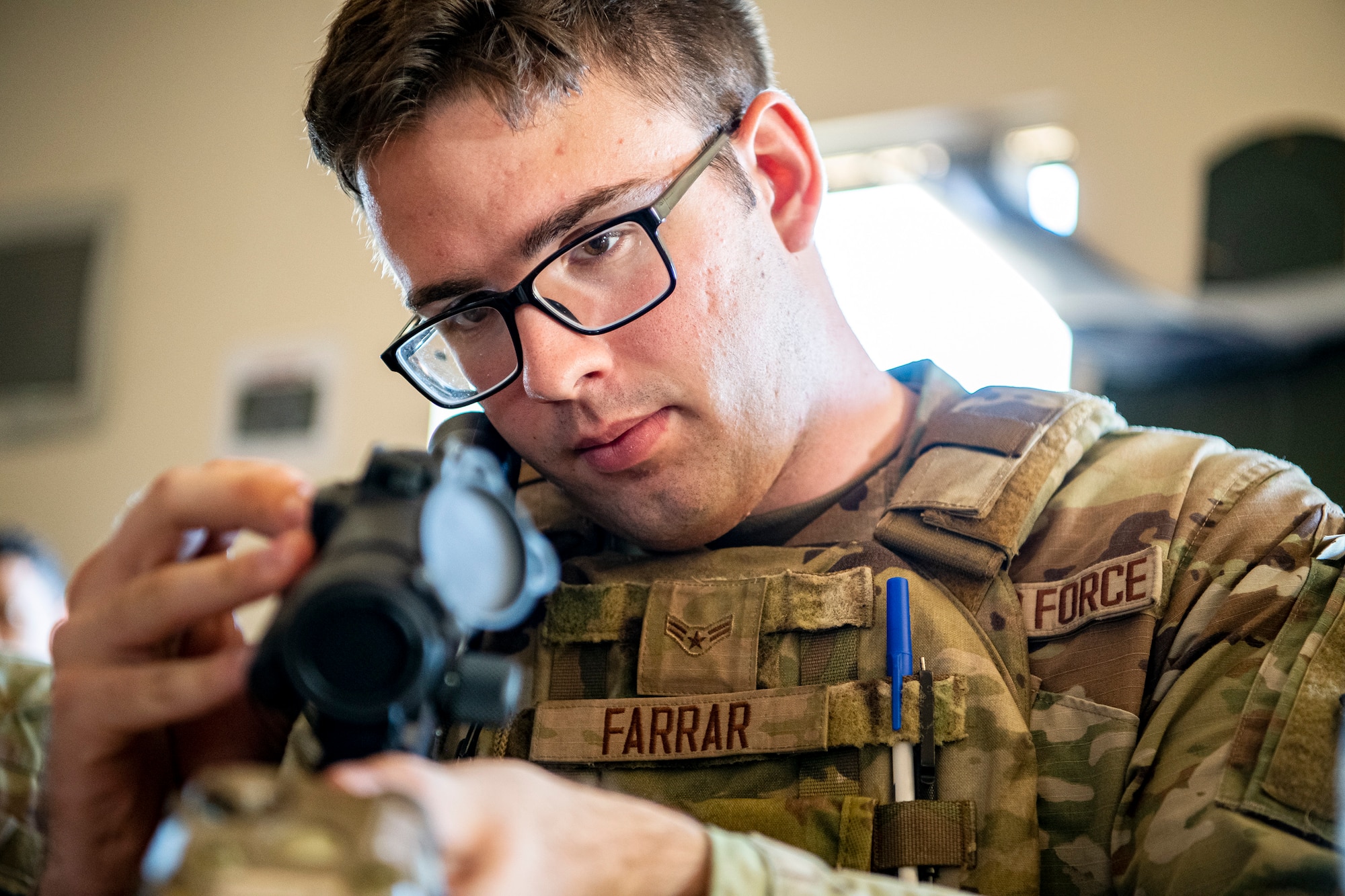 U.S. Air Force Airman 1st Class Trace Farrar, 423d Security Forces Squadron flight member, inspects his M4 carbine prior to a proficiency course at RAF Molesworth, England, Aug. 19, 2022. During the course instructors from the 820th Base Defense Group and 435th Contingency Response Group provided oversight and guidance to help critique and advance the combat arms skills of the defenders from the 423d SFS. (U.S. Air Force photo by Staff Sgt. Eugene Oliver)