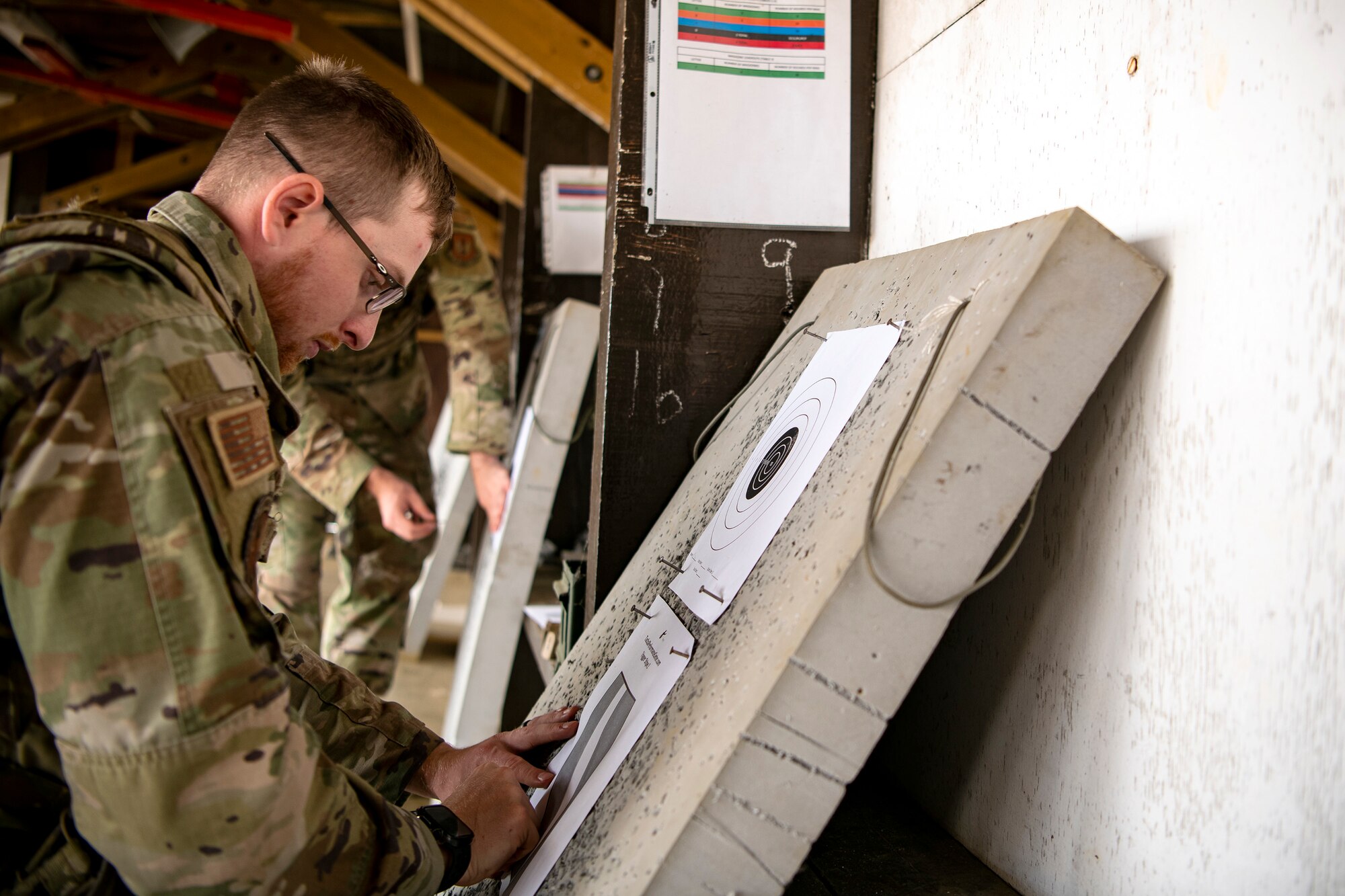 U.S. Air Force Airman 1st Class Isaac John, 423d Security Forces Squadron flight member, places a target sheet during a proficiency course at RAF Molesworth, England, Aug. 19, 2022. During the course instructors from the 820th Base Defense Group and 435th Contingency Response Group provided oversight and guidance to help critique and advance the combat arms skills of the defenders from the 423d SFS. (U.S. Air Force photo by Staff Sgt. Eugene Oliver)