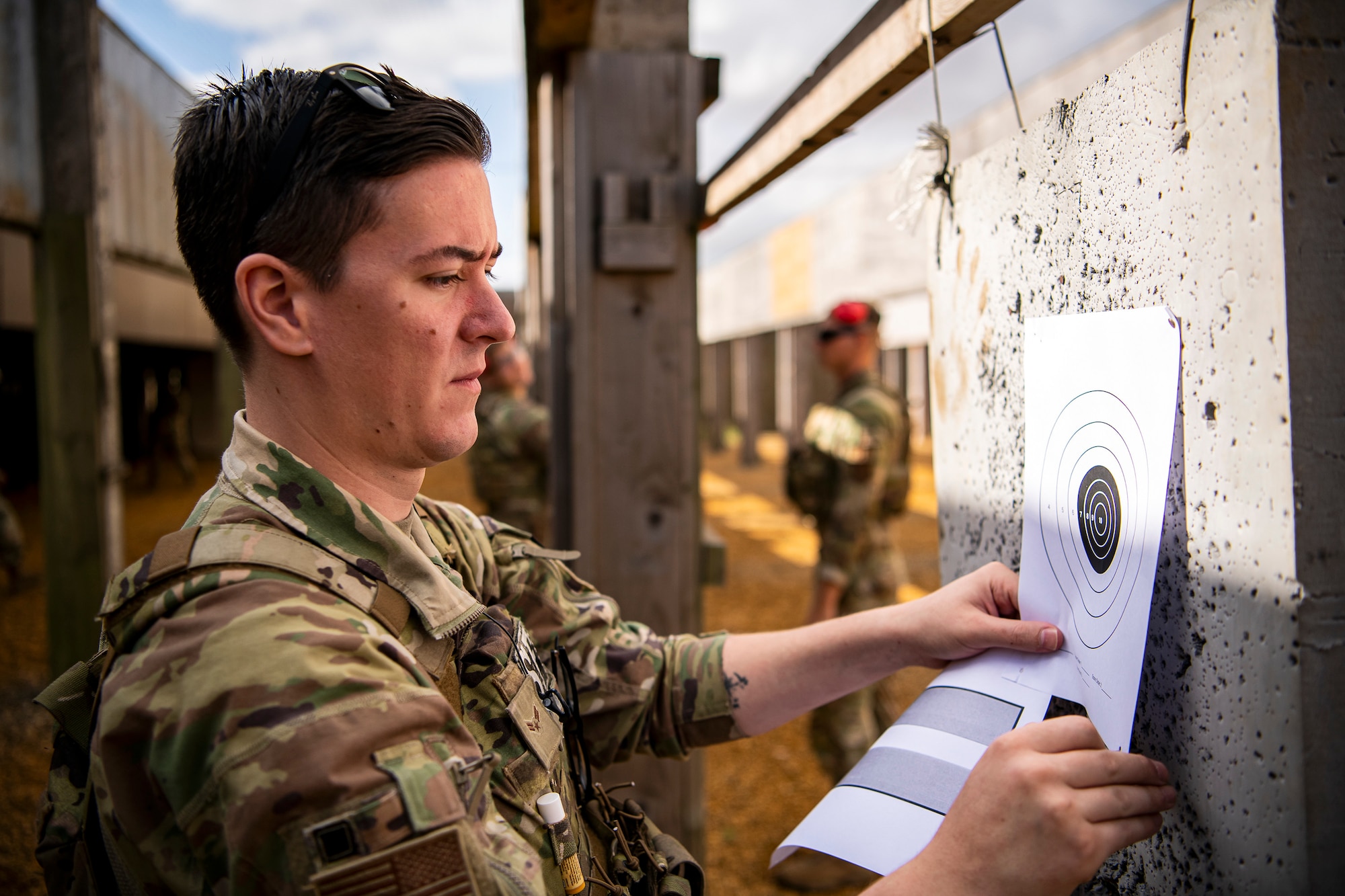 An Airman from the 423d Security Forces Squadron places a target sheet during a proficiency course at RAF Molesworth, England, Aug. 19, 2022. During the course instructors from the 820th Base Defense Group and 435th Contingency Response Group provided oversight and guidance to help critique and advance the combat arms skills of the defenders from the 423d SFS. (U.S. Air Force photo by Staff Sgt. Eugene Oliver)