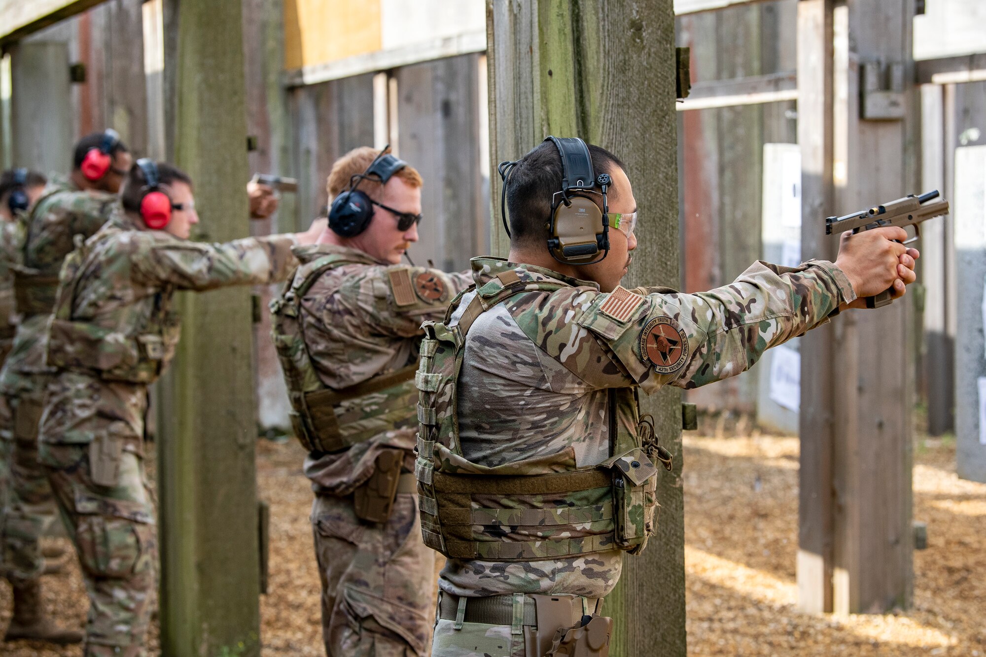 Airmen from the 423d Security Forces Squadron fire their M18 handguns during a proficiency course at RAF Molesworth, England, Aug. 19, 2022. During the course instructors from the 820th Base Defense Group and 435th Contingency Response Group provided oversight and guidance to help critique and advance the combat arms skills of the defenders from the 423d SFS. (U.S. Air Force photo by Staff Sgt. Eugene Oliver)