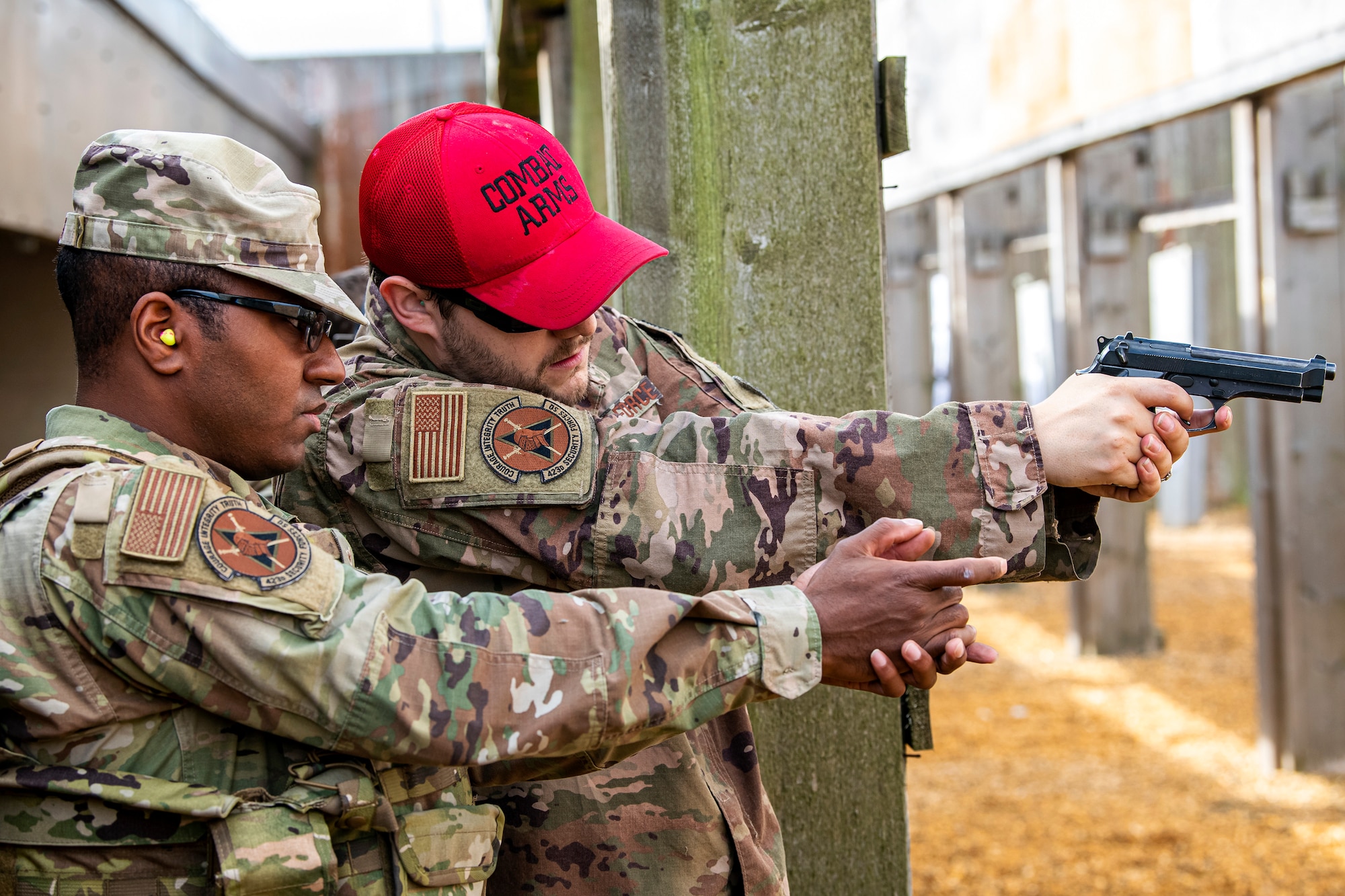 U.S. Air Force Staff Sgt. Rex Harris, right, 423d Security Forces Squadron noncommissioned officer in charge of combat arms and training maintenance, gives instruction to an Airman from the 423d SFS during a proficiency course at RAF Molesworth, England, Aug. 19, 2022. During the course instructors from the 820th Base Defense Group and 435th Contingency Response Group provided oversight and guidance to help critique and advance the combat arms skills of the defenders from the 423d SFS. (U.S. Air Force photo by Staff Sgt. Eugene Oliver)