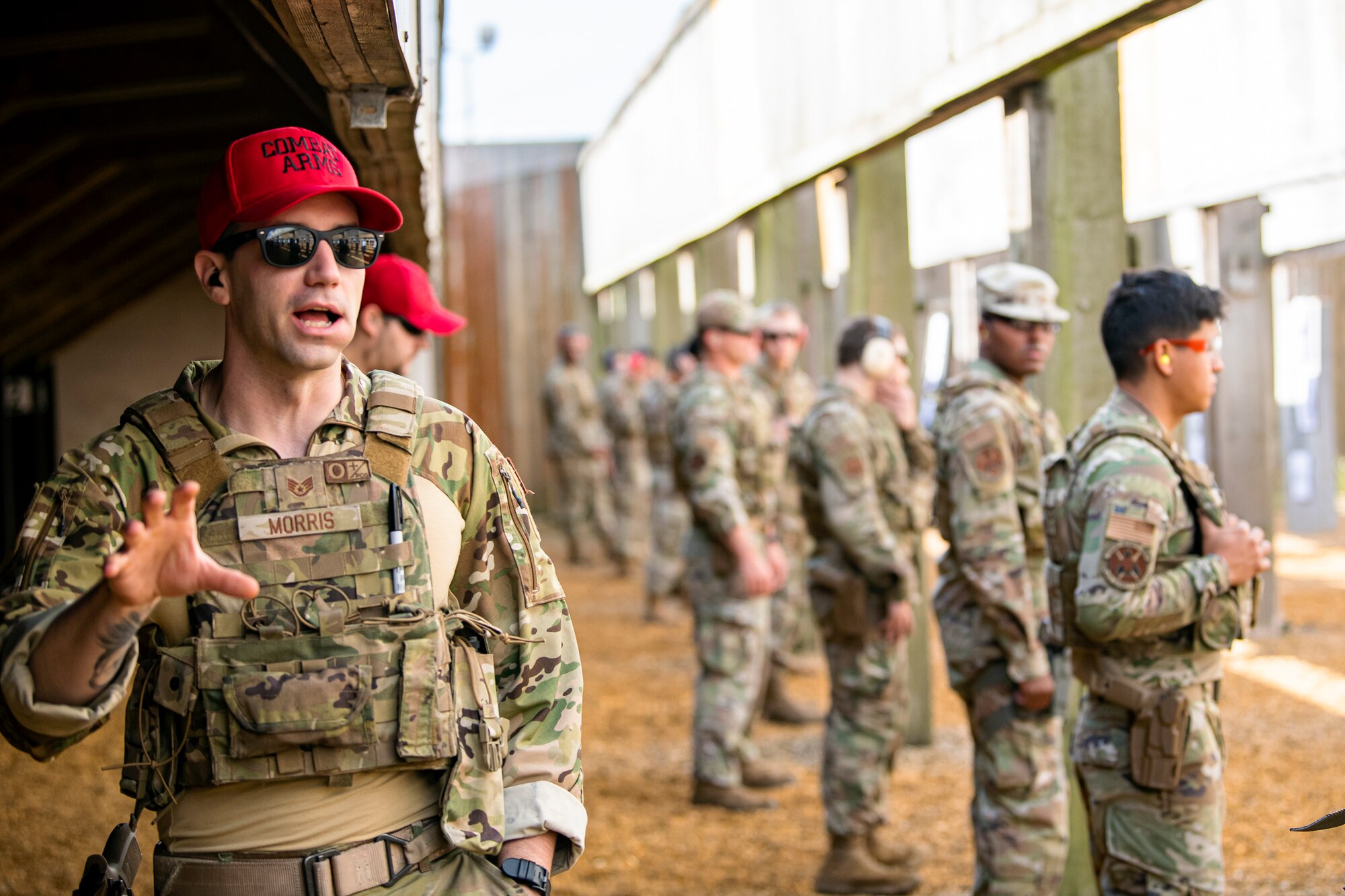 U.S. Air Force Staff Sgt. Tyler Morris, left, 435th Security Forces Squadron noncommissioned officer in charge of combat arms and training maintenance, relays instructions during a proficiency course at RAF Molesworth, England, Aug. 19, 2022. During the course instructors from the 820th Base Defense Group and 435th Contingency Response Group provided oversight and guidance to help critique and advance the combat arms skills of the defenders from the 423d SFS. (U.S. Air Force photo by Staff Sgt. Eugene Oliver)