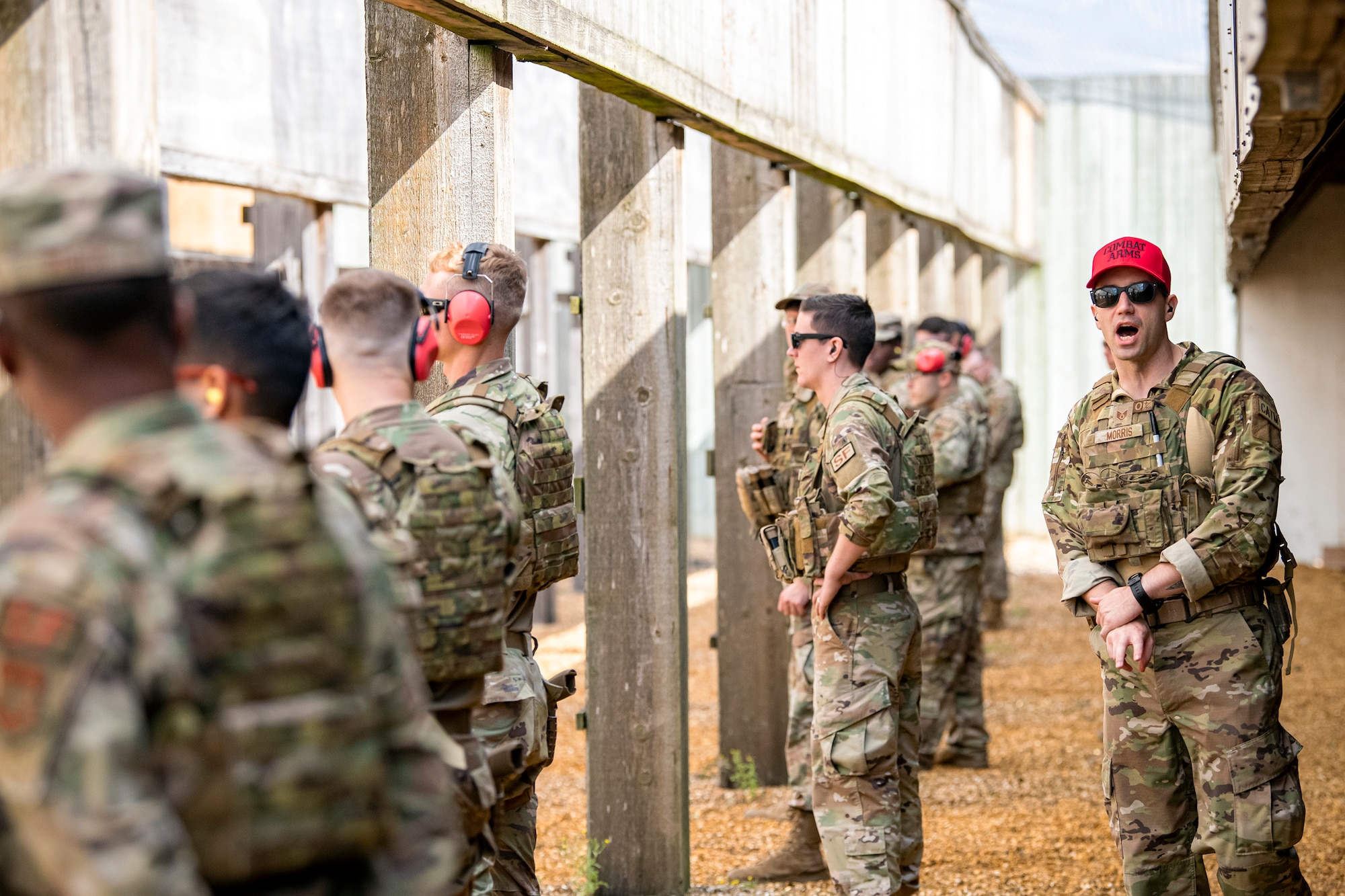 U.S. Air Force Staff Sgt. Tyler Morris, left, 435th Security Forces Squadron noncommissioned officer in charge of combat arms and training maintenance, relays instructions during a proficiency course at RAF Molesworth, England, Aug. 19, 2022. During the course instructors from the 820th Base Defense Group and 435th Contingency Response Group provided oversight and guidance to help critique and advance the combat arms skills of the defenders from the 423d SFS. (U.S. Air Force photo by Staff Sgt. Eugene Oliver)