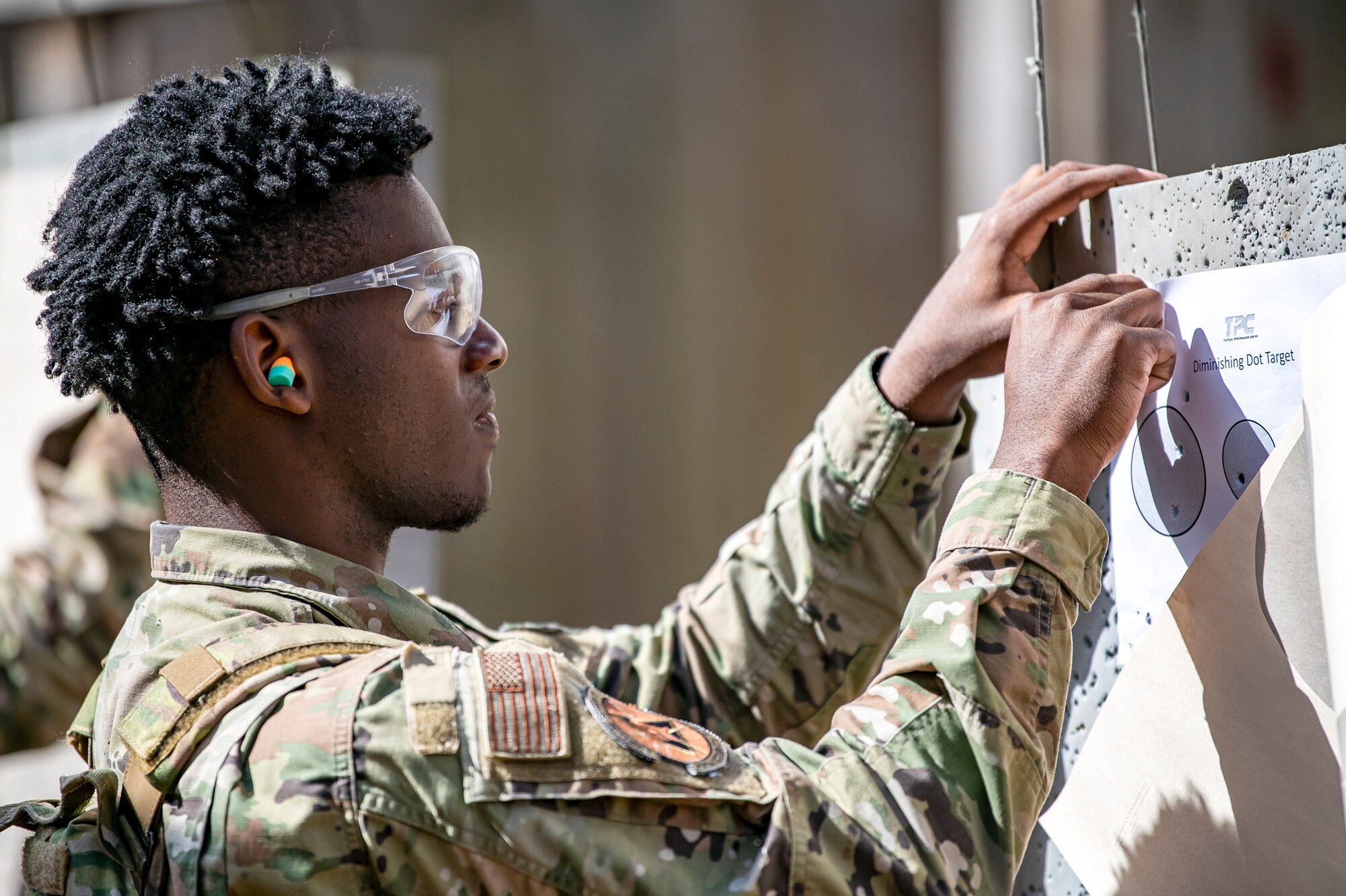 An Airman from the 423d Security Forces Squadron places a target sheet during a proficiency course at RAF Molesworth, England, Aug. 19, 2022. During the course instructors from the 820th Base Defense Group and 435th Contingency Response Group provided oversight and guidance to help critique and advance the combat arms skills of the defenders from the 423d SFS. (U.S. Air Force photo by Staff Sgt. Eugene Oliver)