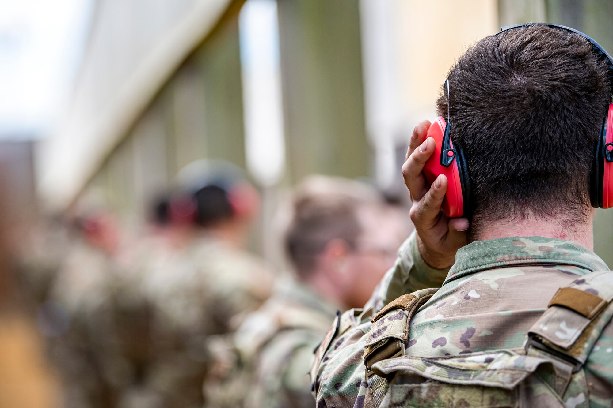 An Airman from the 423d Security Forces Squadron adjusts his ear protection during a proficiency course at RAF Molesworth, England, Aug. 19, 2022. During the course instructors from the 820th Base Defense Group and 435th Contingency Response Group provided oversight and guidance to help critique and advance the combat arms skills of the defenders from the 423d SFS. (U.S. Air Force photo by Staff Sgt. Eugene Oliver)