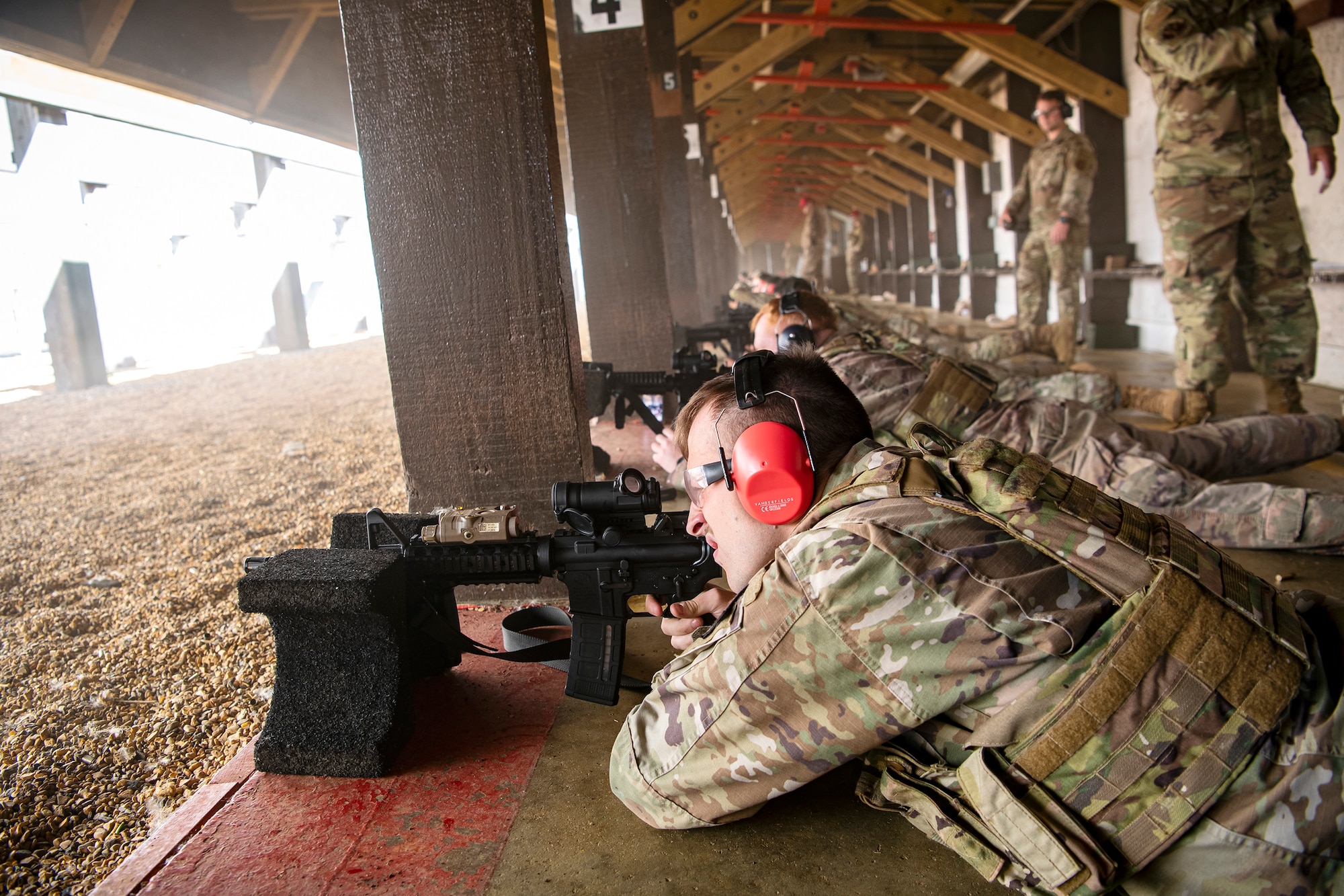 Airmen from the 423d Security Forces Squadron fire their M4 carbines during a proficiency course at RAF Molesworth, England, Aug. 19, 2022. During the course instructors from the 820th Base Defense Group and 435th Contingency Response Group provided oversight and guidance to help critique and advance the combat arms skills of the defenders from the 423d SFS. (U.S. Air Force photo by Staff Sgt. Eugene Oliver)