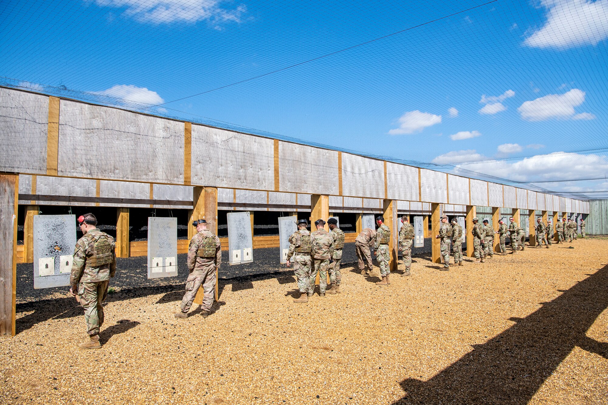 Airmen from the 423d Security Forces Squadron, and their instructors, evaluate score sheets during a proficiency course at RAF Molesworth, England, Aug. 19, 2022. During the course instructors from the 820th Base Defense Group and 435th Contingency Response Group provided oversight and guidance to help critique and advance the combat arms skills of the defenders from the 423d SFS. (U.S. Air Force photo by Staff Sgt. Eugene Oliver)