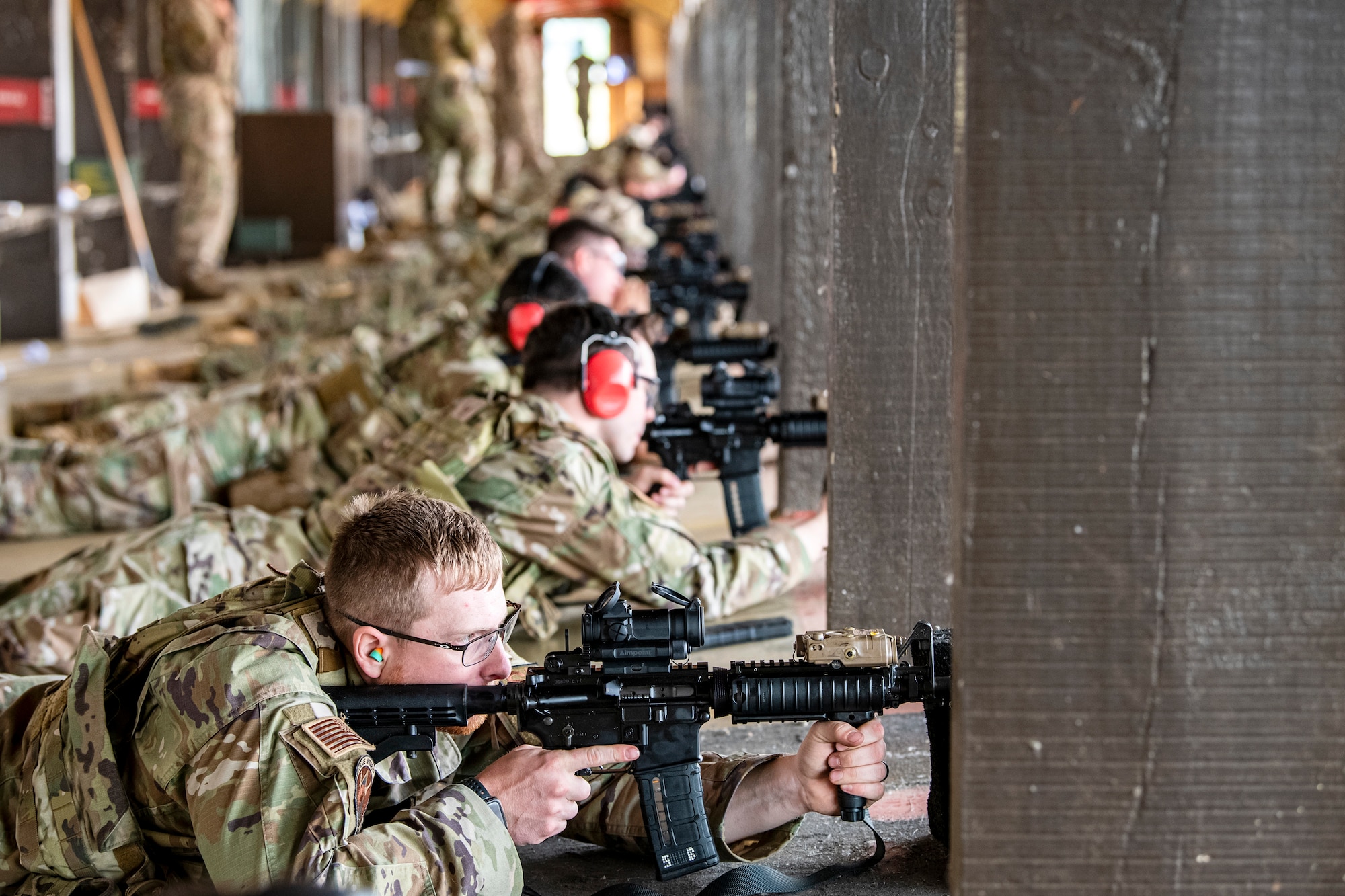 Airmen from the 423d Security Forces Squadron fire their M4 carbines during a proficiency course at RAF Molesworth, England, Aug. 19, 2022. During the course instructors from the 820th Base Defense Group and 435th Contingency Response Group provided oversight and guidance to help critique and advance the combat arms skills of the defenders from the 423d SFS. (U.S. Air Force photo by Staff Sgt. Eugene Oliver)