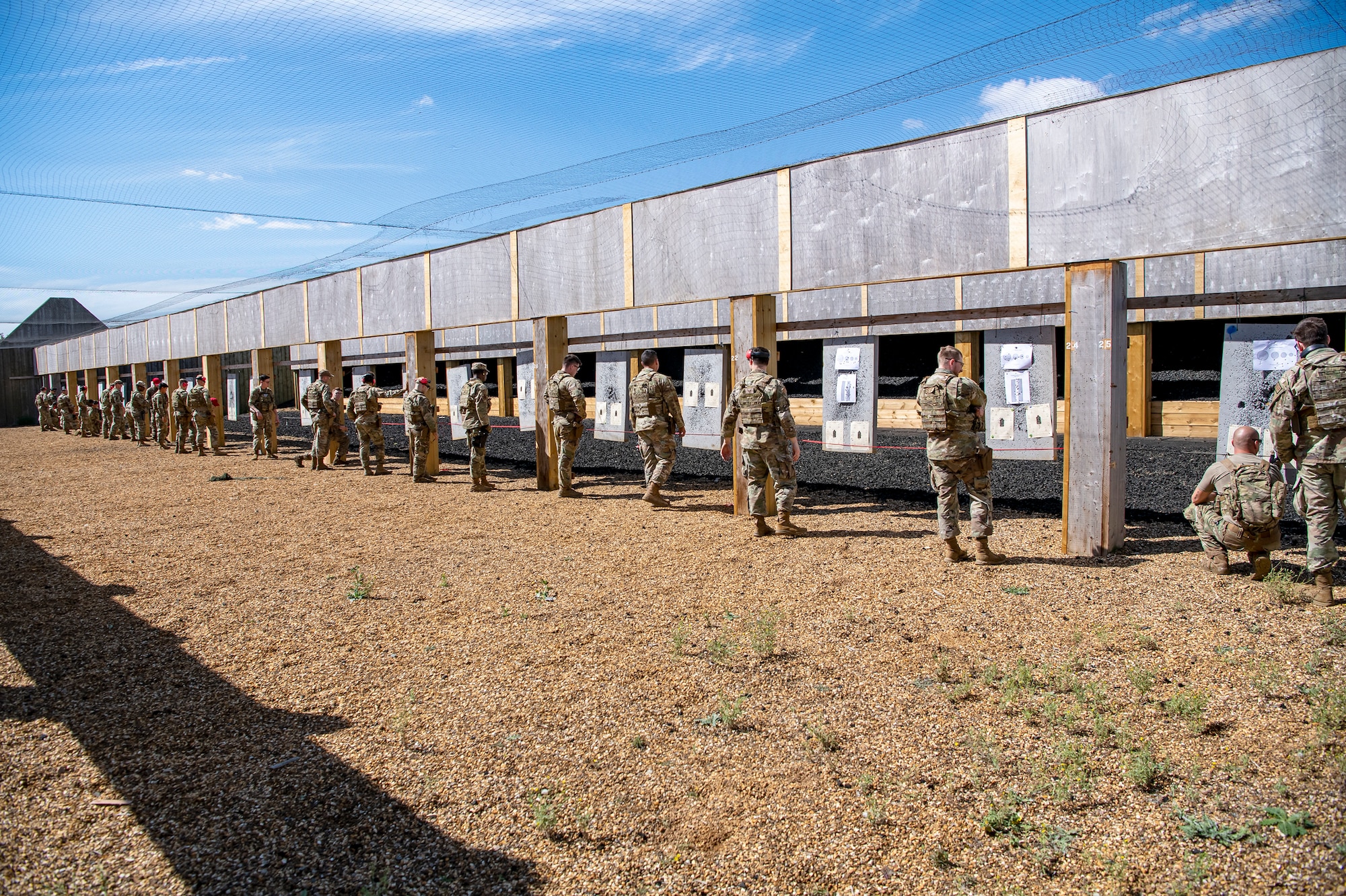 Airmen from the 423d Security Forces Squadron, and their instructors, evaluate score sheets during a proficiency course at RAF Molesworth, England, Aug. 19, 2022. During the course instructors from the 820th Base Defense Group and 435th Contingency Response Group provided oversight and guidance to help critique and advance the combat arms skills of the defenders from the 423d SFS. (U.S. Air Force photo by Staff Sgt. Eugene Oliver)
