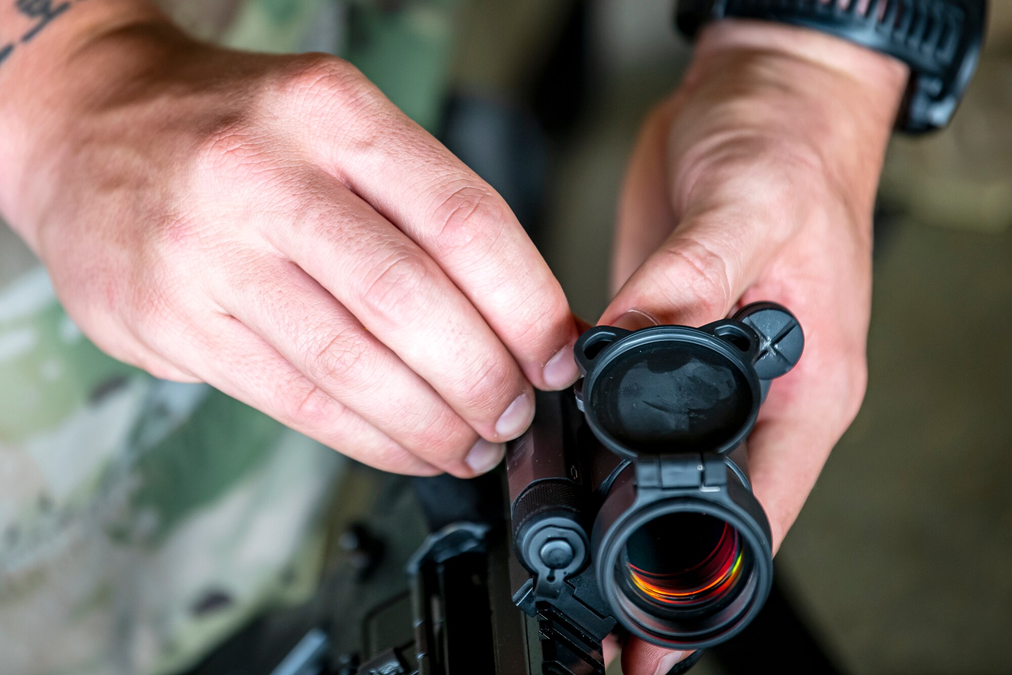 An Airman from the 423d Security Forces Squadron adjusts the sight on an M4 carbine during a proficiency course at RAF Molesworth, England, Aug. 19, 2022. During the course instructors from the 820th Base Defense Group and 435th Contingency Response Group provided oversight and guidance to help critique and advance the combat arms skills of the defenders from the 423d SFS. (U.S. Air Force photo by Staff Sgt. Eugene Oliver)