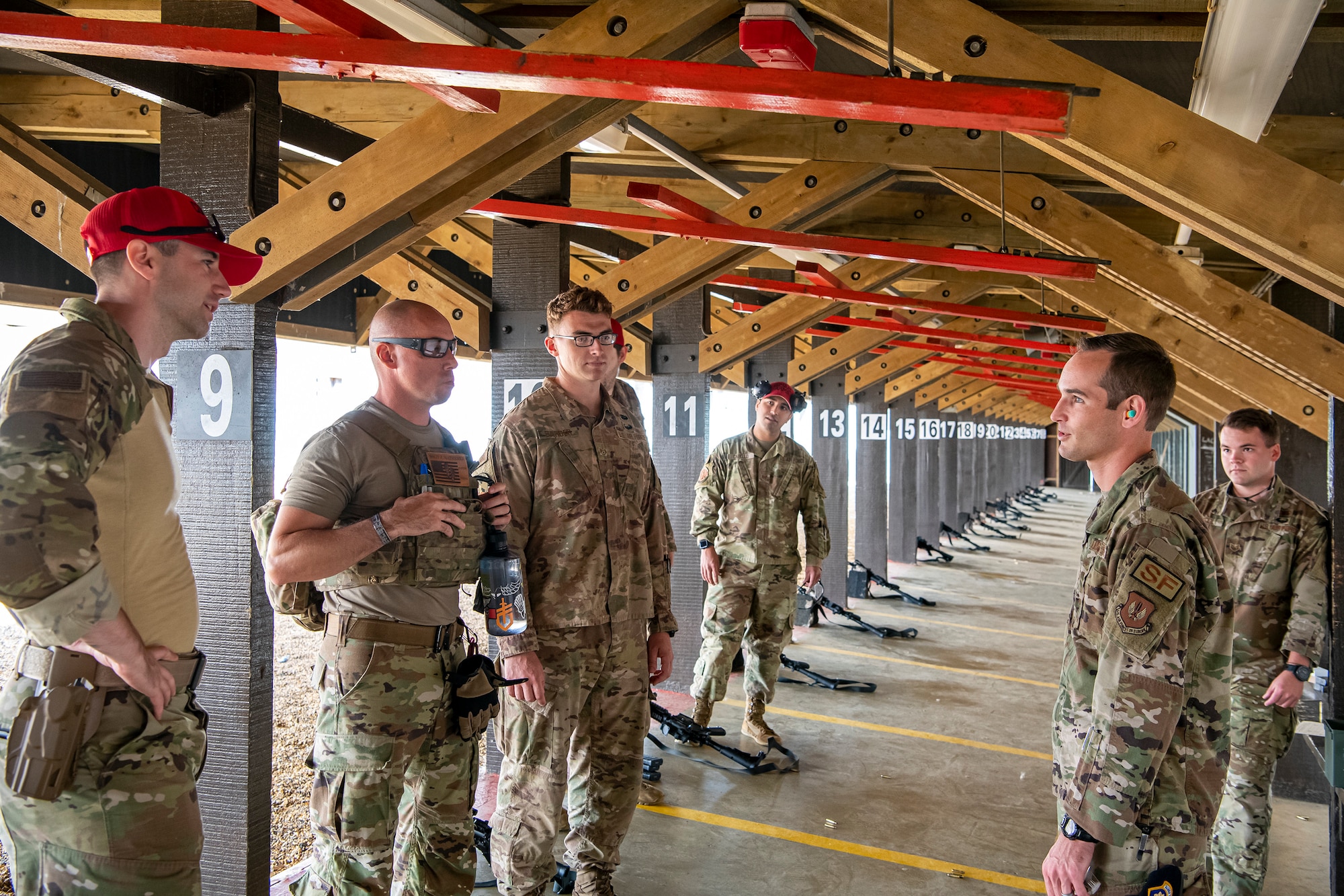 U.S. Air Force Maj. Daniel Merkh, center right, 423d Security Forces Squadron commander, speaks with instructors from the 435th Contingency Response Group and 820th Base Defense Group during a proficiency course at RAF Molesworth, England, Aug. 19, 2022. During the course instructors from the 820th Base Defense Group and 435th Contingency Response Group provided oversight and guidance to help critique and advance the combat arms skills of the defenders from the 423d SFS. (U.S. Air Force photo by Staff Sgt. Eugene Oliver)
