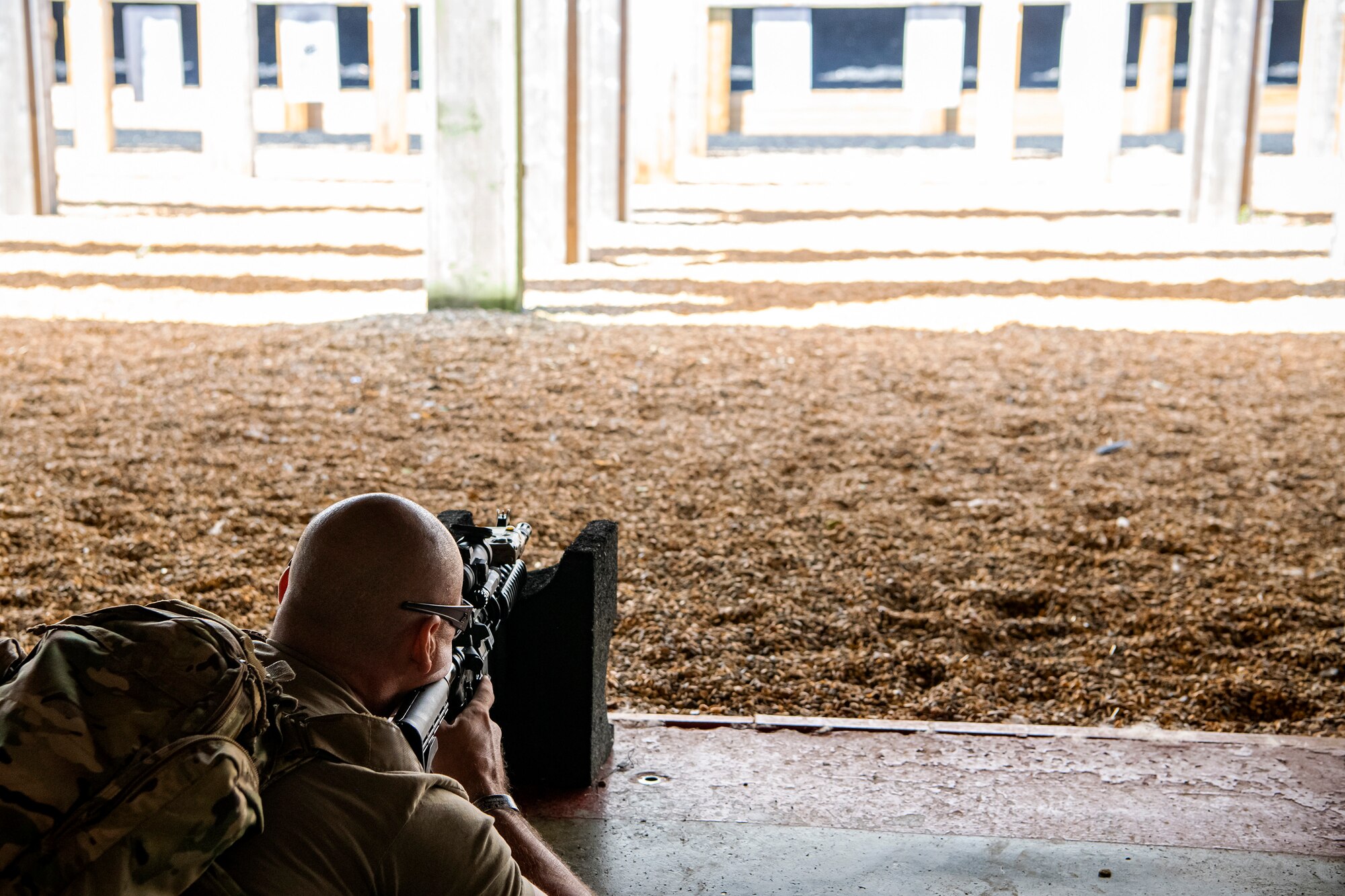 U.S. Air Force Staff Sgt. James Matherly, center, 824th Base Defense Squadron squad leader, fires an M4 carbine during a proficiency course at RAF Molesworth, England, Aug. 19, 2022. During the course instructors from the 820th Base Defense Group and 435th Contingency Response Group provided oversight and guidance to help critique and advance the combat arms skills of the defenders from the 423d SFS. (U.S. Air Force photo by Staff Sgt. Eugene Oliver)