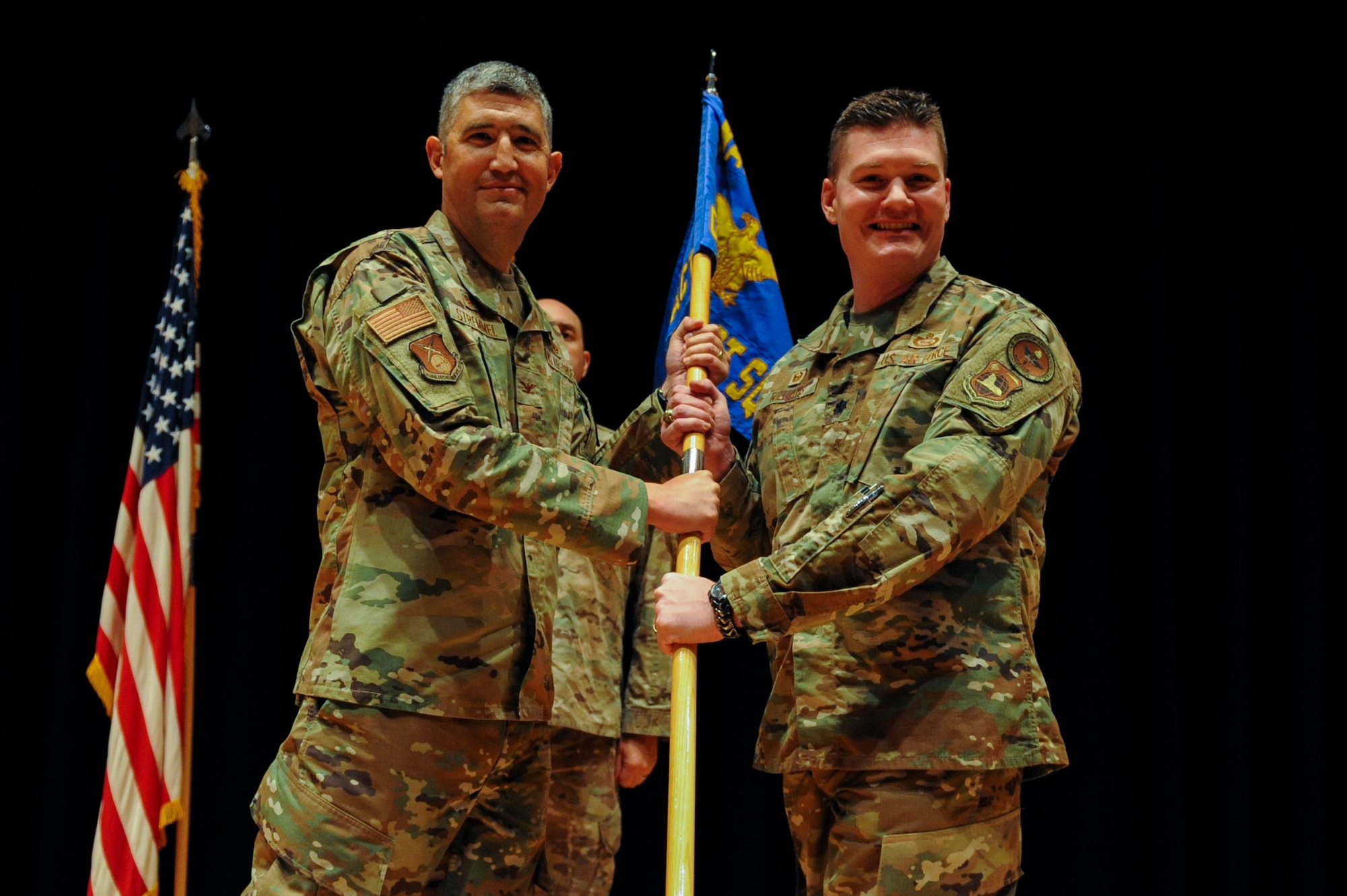 Lt. Col. Michael Williams, inbound commander of the Global Activities Squadron, receives the guidon from Col. Kenneth Stremmel, Global Exploitation Intelligence Group commander, during the squadron’s change of command ceremony here, June 21, 2022. GXA’s mission is to direct, manage, and execute Human Intelligence activities in order to prevent strategic surprise and provide decision advantage to warfighters, defense planners, U.S. Air Force senior leaders and policy makers. Williams previously served as the deputy chief for the Plans and Operations Directorate, National Air and Space Intelligence Center. (U.S. Air Force photo by Senior Airman Kristof J. Rixmann)