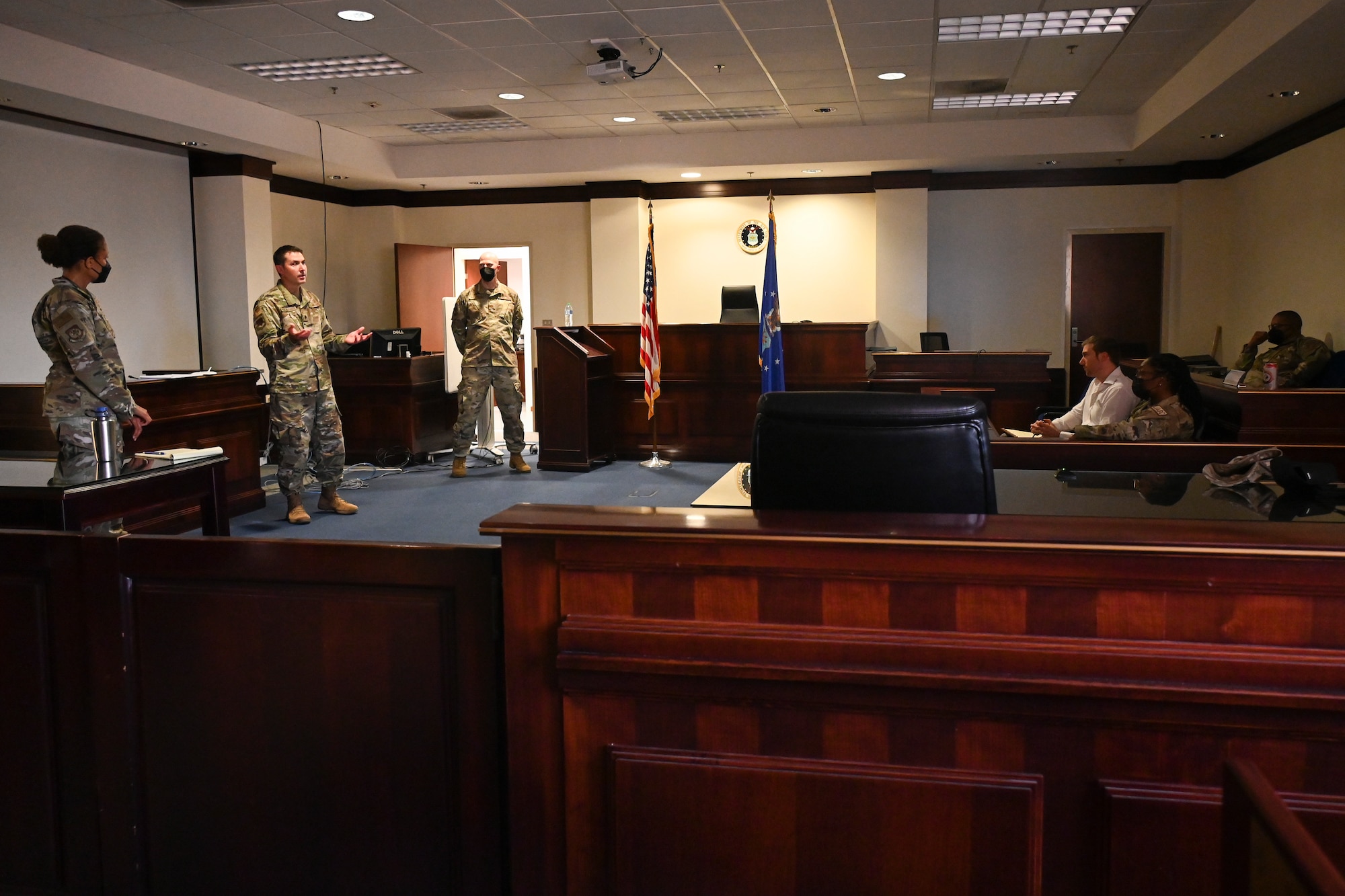 U.S. Air Force Maj. Jacqueline Brown (left), an assistant staff judge advocate assigned to the 175th Wing, Maryland Air National Guard, U.S. Air Force Lt. Col. Jason Van Wagner (center), Staff Judge Advocate, Maryland Air National Guard, and U.S. Air Force Maj. Jeff Lorek, Deputy Staff Judge Advocate, Maryland Air National Guard, conduct a legal briefing during their annual training July 20, 2022 at Aviano Air Base, Italy.