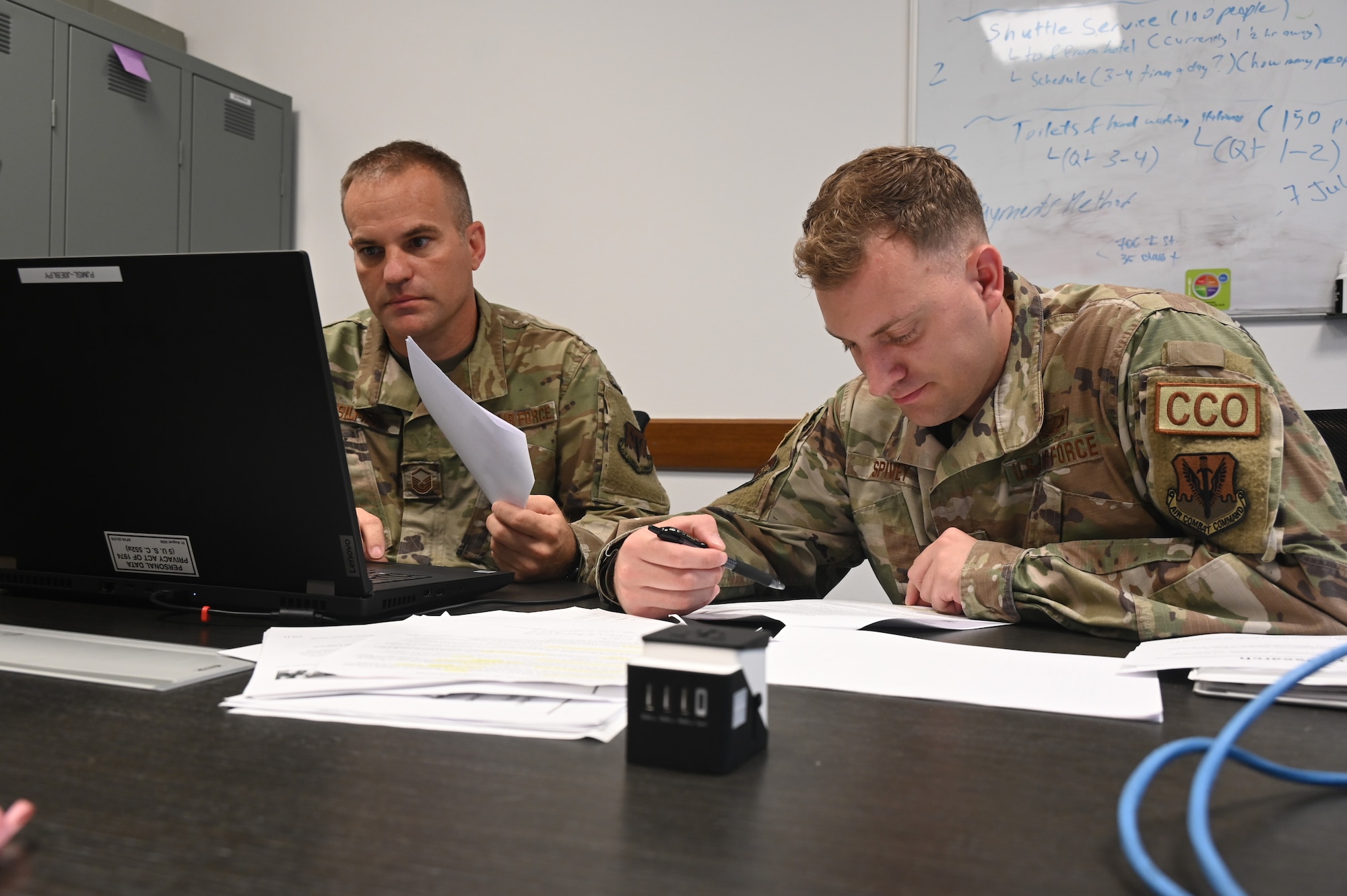 U.S. Air Force Master Sgt. Cory Selfies (left), a contract specialist assigned to the 175th Wing, Maryland Air National Guard and U.S. Air Force Staff Sgt. Evan Spivey, a contract specialist assigned to the 175th Wing, Maryland Air National Guard, worked on various contract writing and file systems during annual training, July 18, 2022, at Aviano Air Base, Italy.