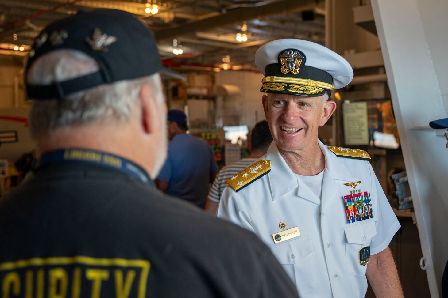 Vice Adm. Daniel Dwyer, commander, U.S. 2nd Fleet, greets visitors, volunteers, workers aboard the USS Hornet Sea, Air and Space Museum during the 100th Anniversary of the Aircraft Carrier ceremony in Alameda, Calif., August 13.