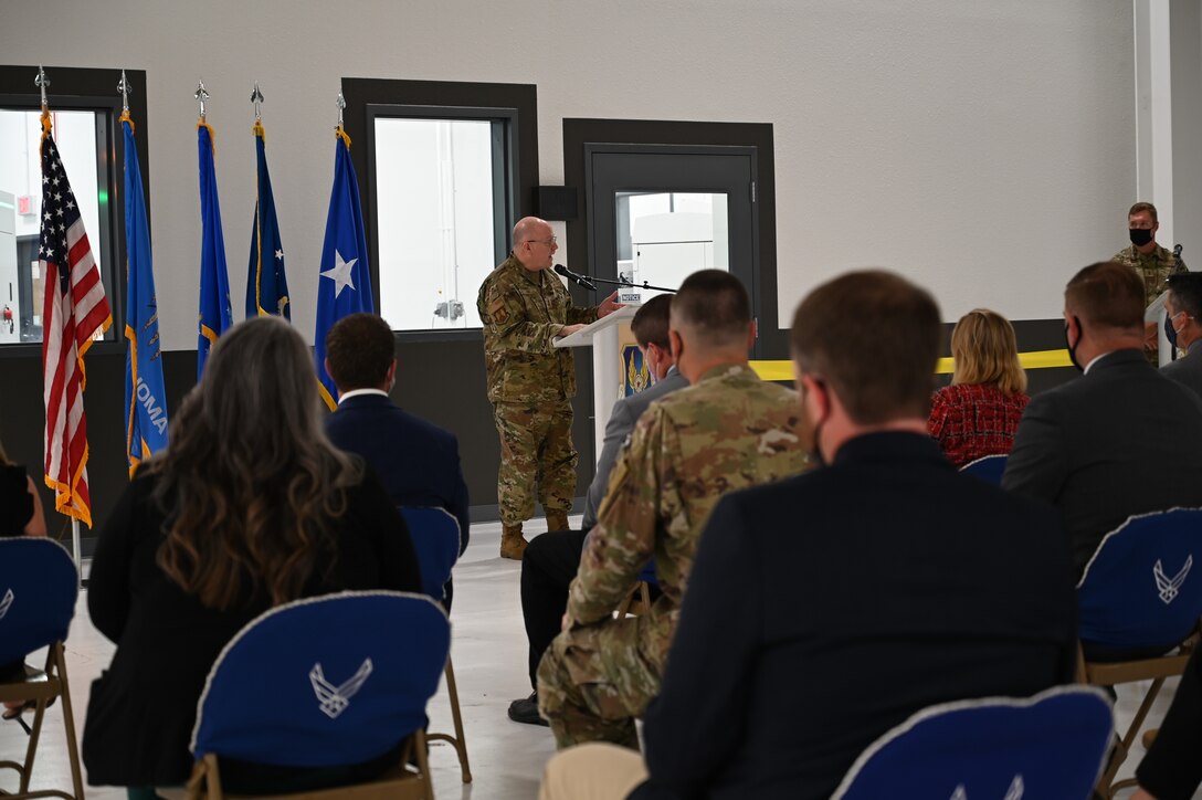 Maj. Gen. Jeff King, Oklahoma City Air Logistics Complex commander, stands behind podium addressing guests at the ribbon cutting for the second Reverse Engineering and Critical Tooling lab.
