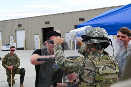 Two soldiers practice riot shield techniques