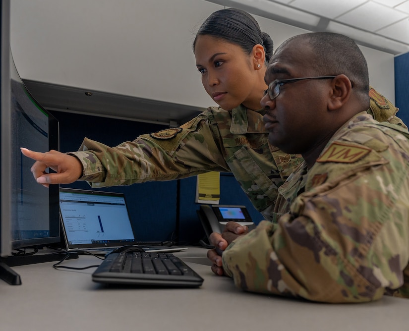 U.S. Air Force Tech. Sgt. Jennifer Gloria “JT” Thomas, 441st Vehicle Support Chain Operations Squadron, noncommissioned officer in charge of vehicle disposition and lease management, assists U.S. Air Force Staff Sgt. Miguel Graham, 441st VSCOS approving official fleet manager, with vehicle package tasks at Joint Base Langley-Eustis, Virginia.