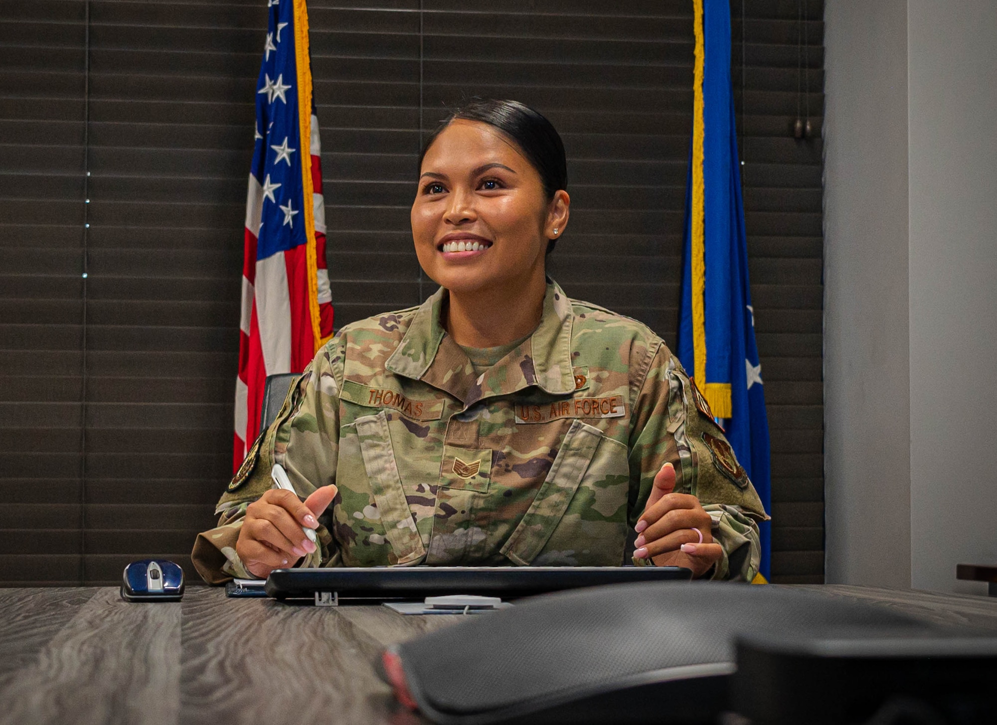U.S. Air Force Tech. Sgt. Jennifer Gloria “JT” Thomas, 441st Vehicle Support Chain Operations Squadron noncommissioned officer in charge of vehicle disposition and lease management, smiles when taking notes while discussing the 5/6 club at Joint Base Langley-Eustis.
