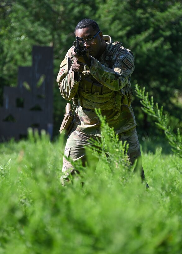 Tech. Sgt. Raymond Simpson, 316th Security Support Squadron NCO in charge of training, aims his M4 Carbine at a target during an annual weapons proficiency training exercise at Joint Base Andrews, Md., Aug. 23, 2022. The exercise allowed defenders to enhance their technical skills during three different simulations. (U.S. Air Force photo by Airman 1st Class Isabelle Churchill)