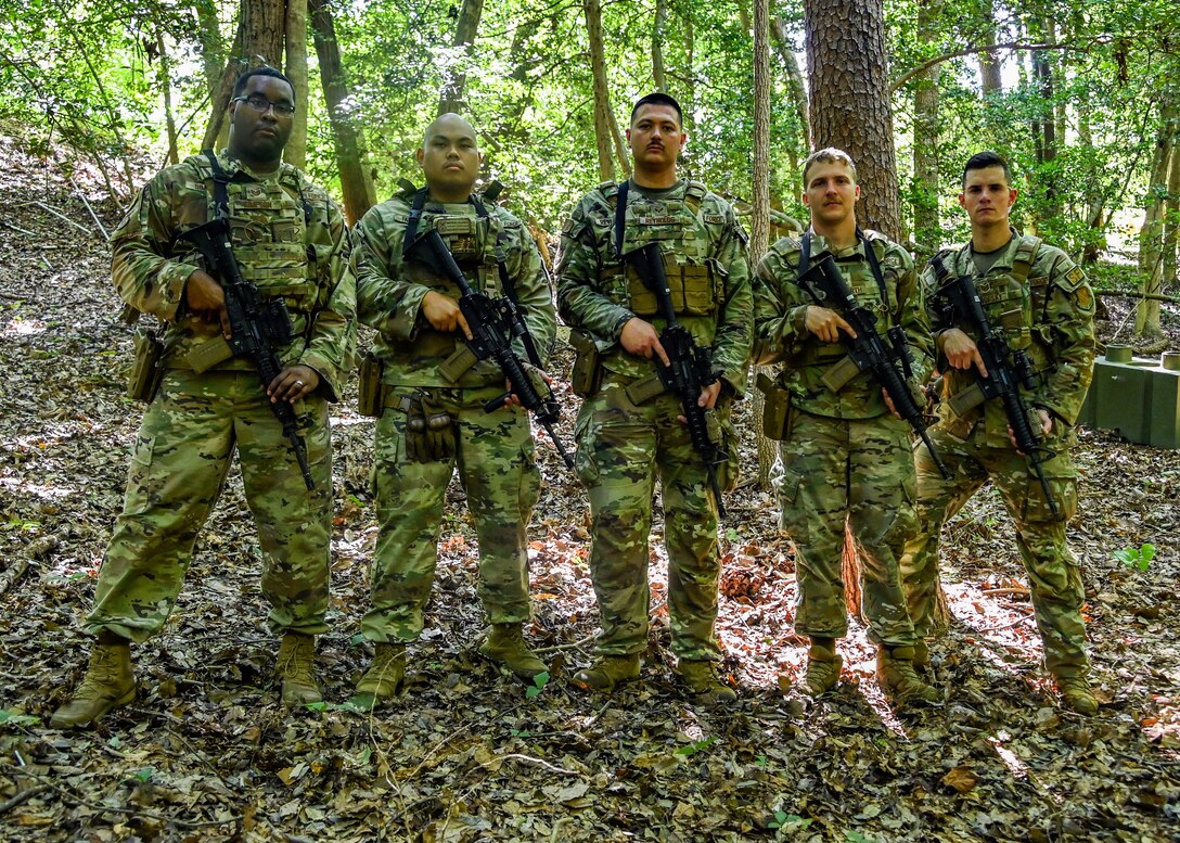 Five members of the 316th Security Support Squadron pose for a group photo following an annual weapons proficiency training exercise at Joint Base Andrews, Md., Aug. 23, 2022. The exercise, known as “shoot, move, communicate” focuses on maintaining and enhancing technical skills of defenders to ensure that they are always prepared to protect and defend JBA and other military installations from threats. (U.S. Air Force photo by Airman 1st Class Isabelle Churchill)