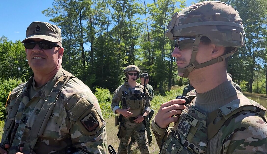 Sgt. 1st Class Ron Hesson, Army National Group Operations Group Wolf Fire Support Team senior observer, coach/trainer, observes Soldiers from 1st Battalion, 134th Field Artillery Regiment, 37th Infantry Brigade Combat Team, during a call for fire mission at Northern Strike 2022 on August 9, 2022, at Camp Grayling, Michigan.