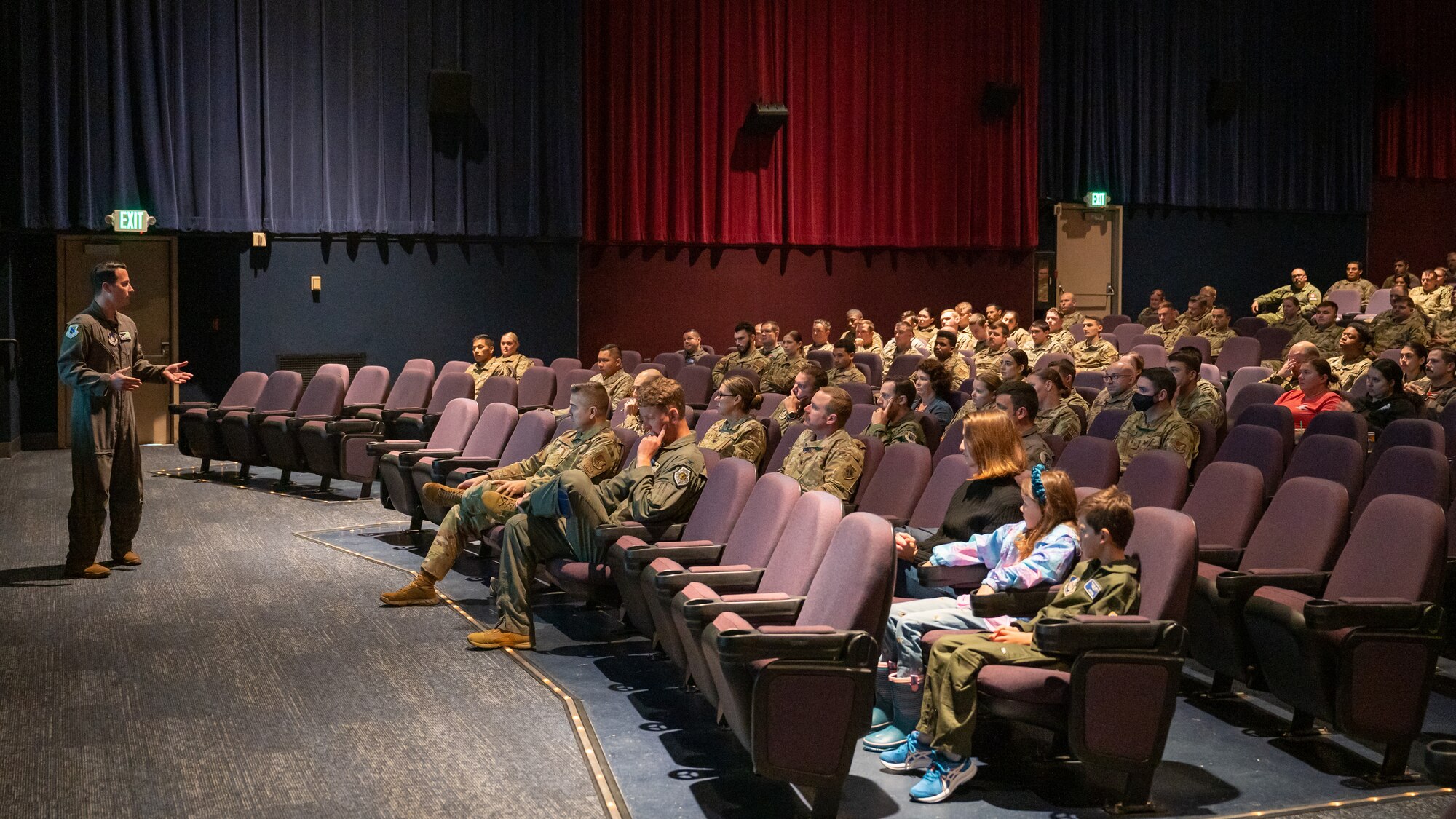 Photo U.S. Air Force Col. Kevin Jamieson speaking to the crowd inside a theater.