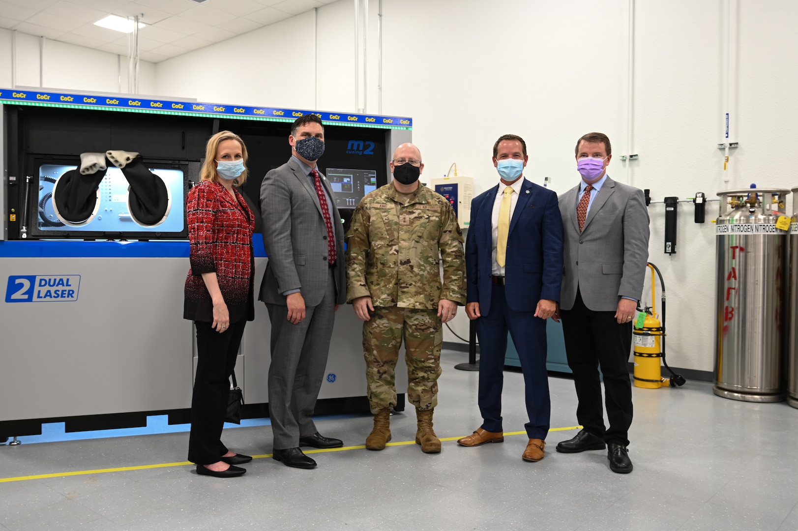 (From left to right) Amy Gowder, president & CEO of GE Military Systems, John Sneden, director of the Air Force Life Cycle Management Center’s Propulsion Directorate, Maj. Gen. Jeff King, commander of the Oklahoma City Air Logistics Complex, Geoffrey Camp, director of Oklahoma’s Aerospace and Defense initiative, and Chris Schuppe, general manager of engineering and technology at GE Additive, stand in front of additive manufacturing 3D printer.