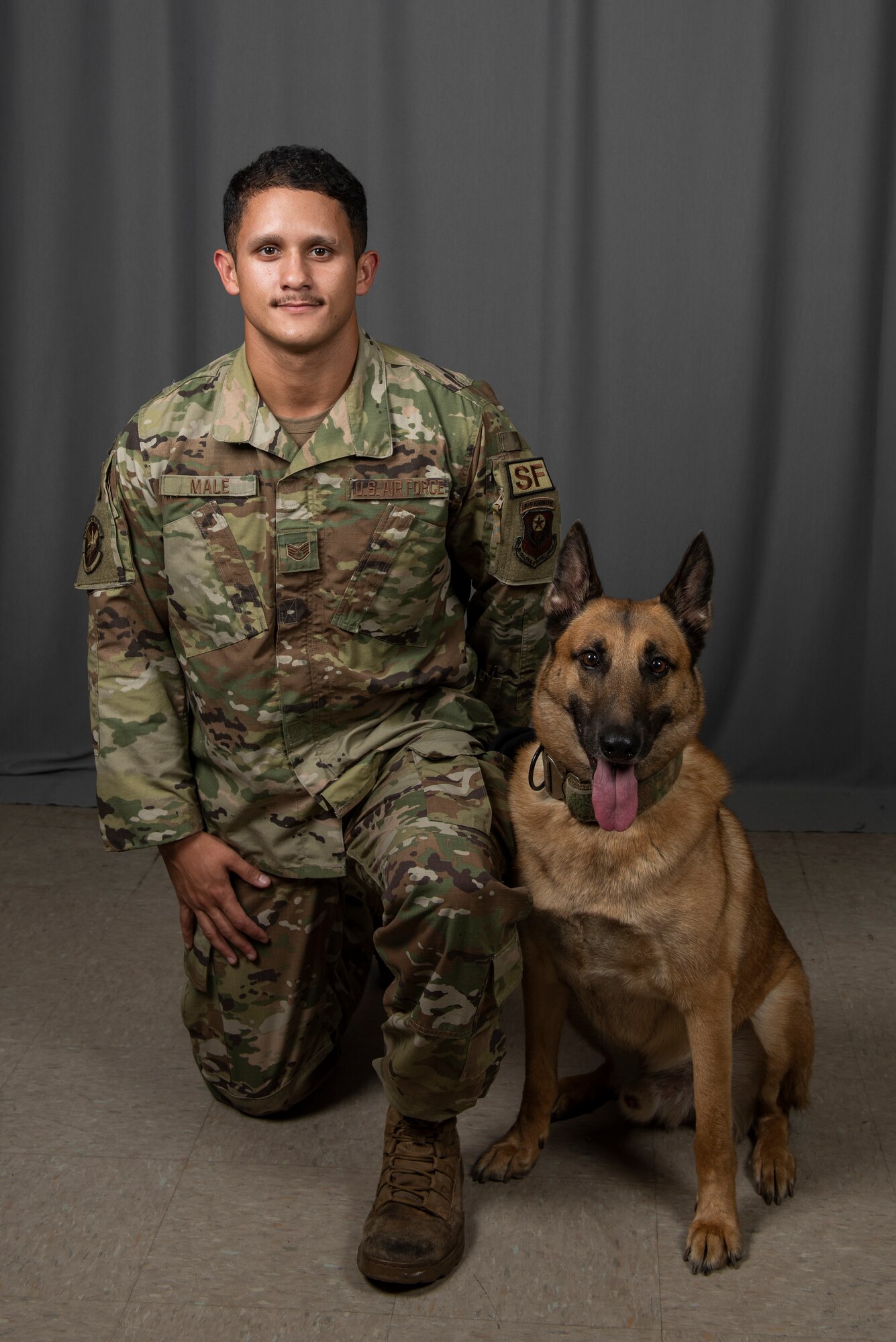 U.S. Air Force Staff Sgt. Brandon Male, a 1st Special Operations Security Forces Squadron Military Working Dog handler, poses for a photo with his dog, Ronny, a retired 1st SOSFS MWD, Aug. 23, 2022, at Hurlburt Field, Florida. Throughout his distinguished career, Ronny was a key part of 30 successful missions to include direct support to United States President Joe Biden, as well as former U.S. President Donald Trump, former U.S. Vice President Mike Pence and a number of Department of State officials, among others. Additionally, Ronny deployed to Eskan Village, Saudi Arabia.