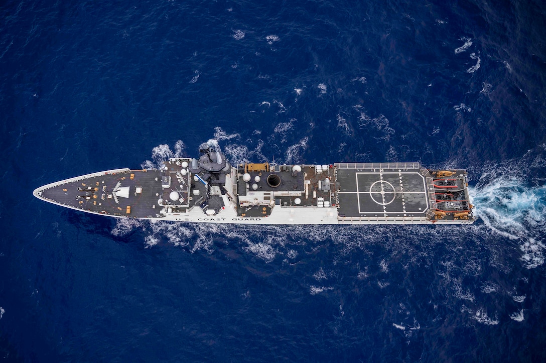 An overhead view of a ship traveling through waters.