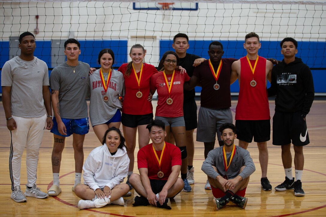 The Red Bulls, the winners of the competition, and the Casa Migos pose for a photo after the final game of the volleyball tournament hosted by Marine Corps Community Services at the Marine Dome on Marine Corps Air Station Cherry Point, North Carolina, Aug. 19, 2022. The event was held to boost unit moral and foster friendly competition between installation personnel.  (U.S. Marine Corps photo by Lance Cpl. Tristen Reed)
