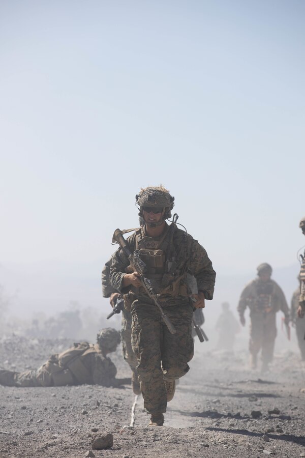 U.S. Marine Corps Staff Sgt. Brandan Sutherland, an infantry unit leader with 1st Battalion, 6th Marine Regiment, 2d Marine Division, crosses a breach on Range 400 during Integrated Training Exercise (ITX) on Marine Corps Air-Ground Combat Center, Twentynine Palms, May 16, 2022.