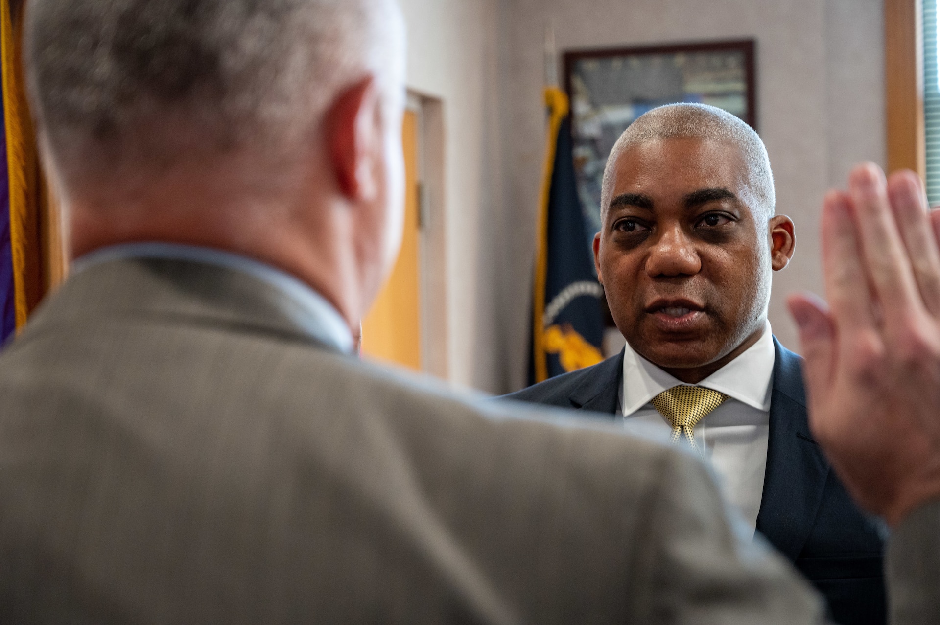 Man swears into office with his right hand raised