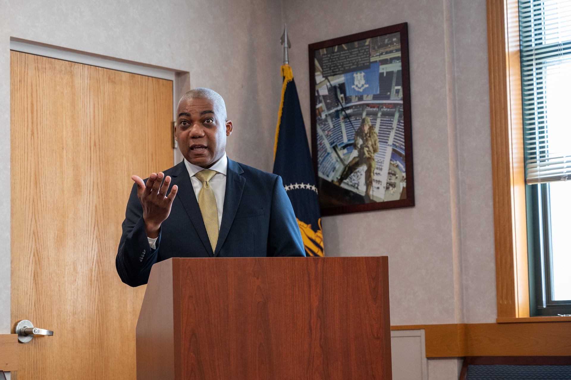 Man in suit speaks at podium
