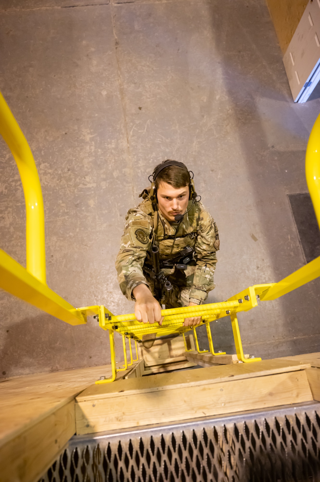 Senior Airman Christian Ward, 341st Missile Security Operations Squadron tactical response force defender, climbs a ladder in the newly renovated security forces training area Aug. 18, 2022, at Malmstrom Air Force Base, Mont.