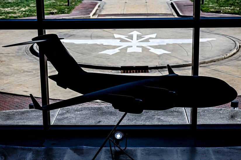 A C-17 Globemaster III model is displayed at the 305th Air Mobility Wing Consolidated Maintenance Operations Facility building prior to the arrival of U.S. Air Force Maj. Gen. Albert Miller, Aircrew Task Force director, at Joint Base McGuire-Dix-Lakehurst, N.J. on Aug. 25, 2022. Miller has amplified community outreach to aircrew members in the field through increased site visits. These visits provide a chance to have meaningful discussions with all aircrew members to capture operational, quality of life, and quality of service concerns to inform policy decisions.