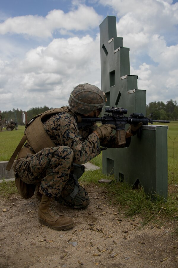 U.S. Marine Corps Lance Cpl. Justin Sour, a Parker, Colorado, native and amphibious assault crew chief with 2d Assault Amphibian Battalion, 2d Marine Division, fires an M4 carbine during a deployment for training (DFT) at Joint Forces Training Center Camp Shelby, Mississippi, May 24, 2022.