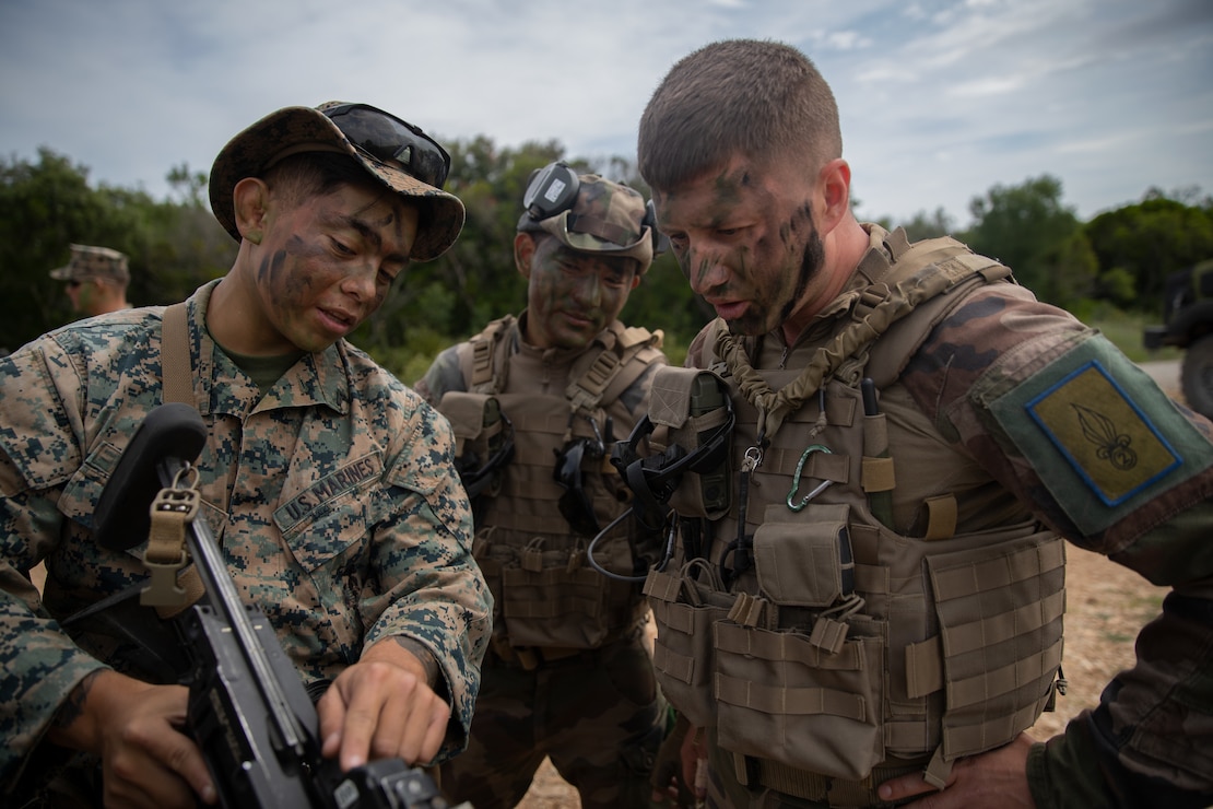 U.S. Marine Corps Lance Cpl. Jonathan Cabrera, a rifleman with 3rd Battalion, 6th Marine Regiment, 2d Marine Division,  shows a French Foreign Legionnaire how to operate a M320 grenade launcher at Nimes, France, May, 24, 2022. This was part of a bilateral training event with the French Foreign Legion that challenged the forces with physical and tactical training, as well as provided the opportunity to exchange knowledge and strengthen bonds.(U.S. Marine Corps photo by Cpl. Michael Virtue)