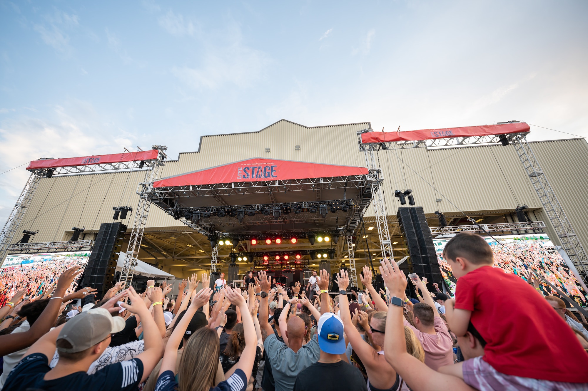Audience members put their hands in the air during a song played by the rock band Hoobastank at Rock Fest Aug. 20, 2022, at Malmstrom Air Force Base, Mont.