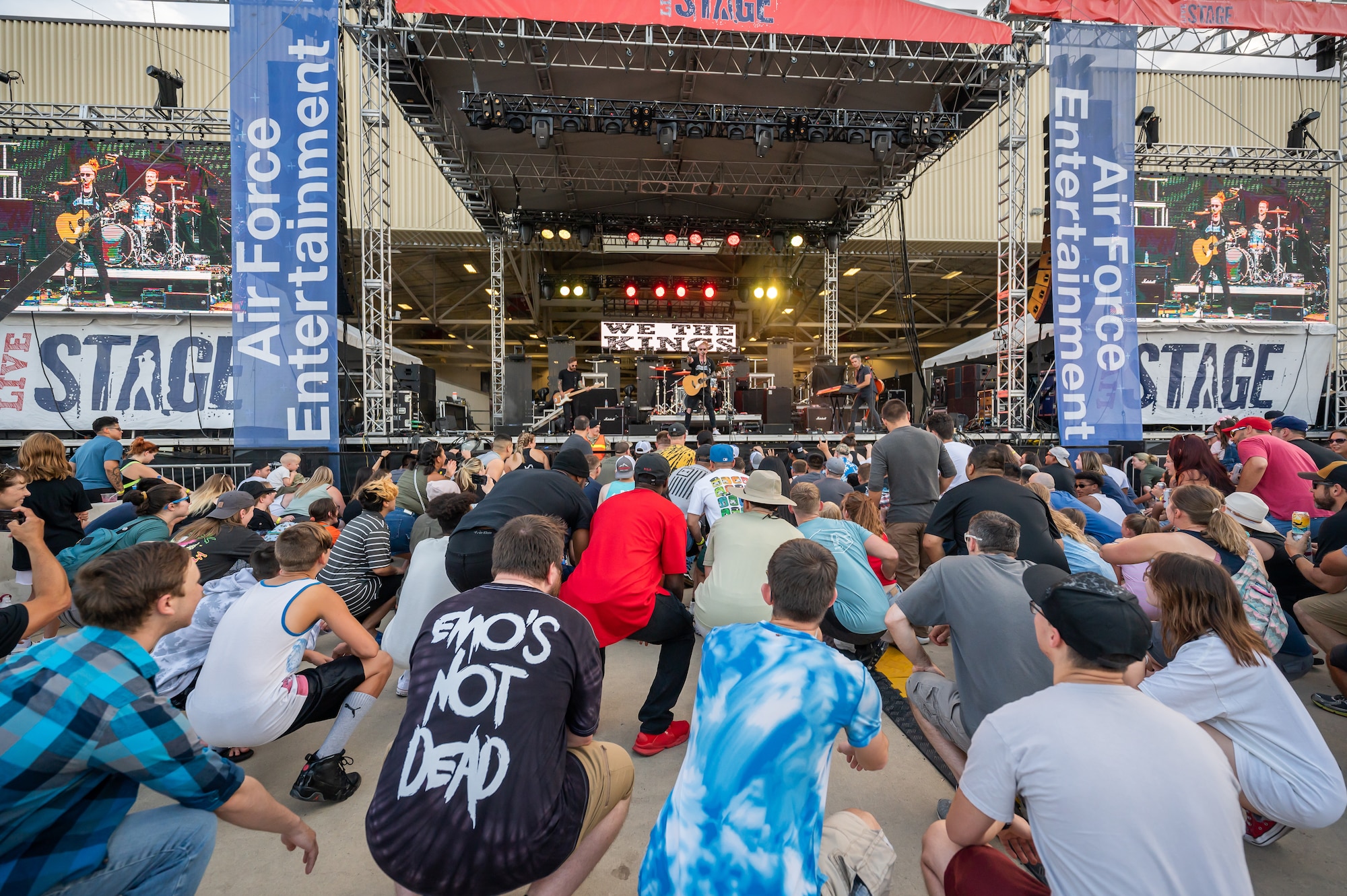 Audience members crouch during a song played by the rock band We the Kings during Rock Fest Aug. 20, 2022, at Malmstrom Air Force Base, Mont.