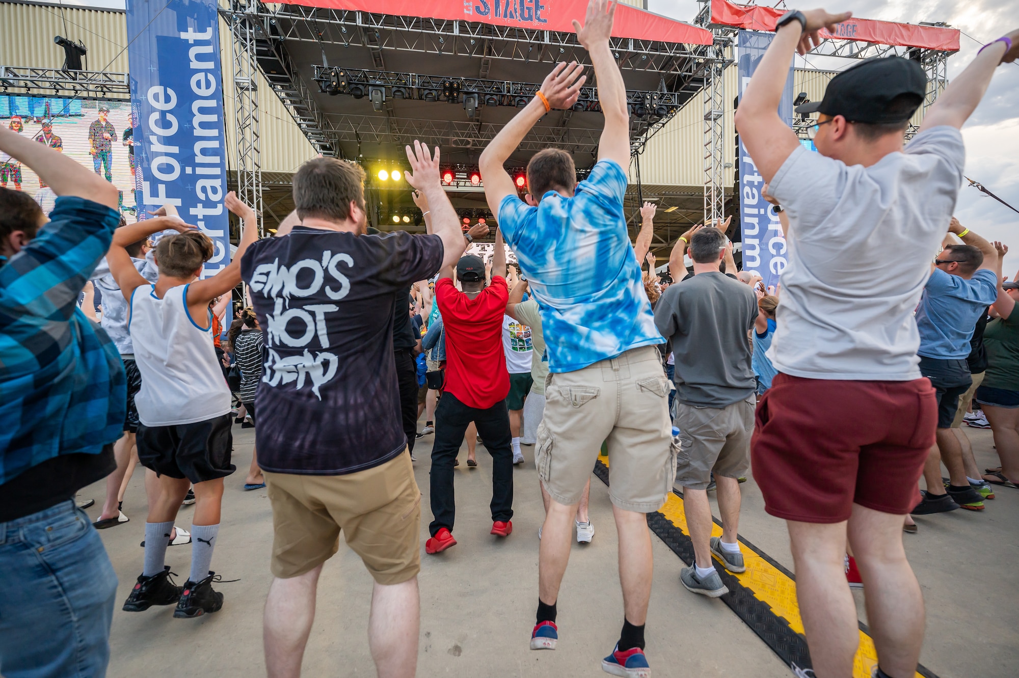 Audience members jump in the air during a song played by the rock band We the Kings at Rock Fest Aug. 20, 2022, at Malmstrom Air Force Base, Mont.